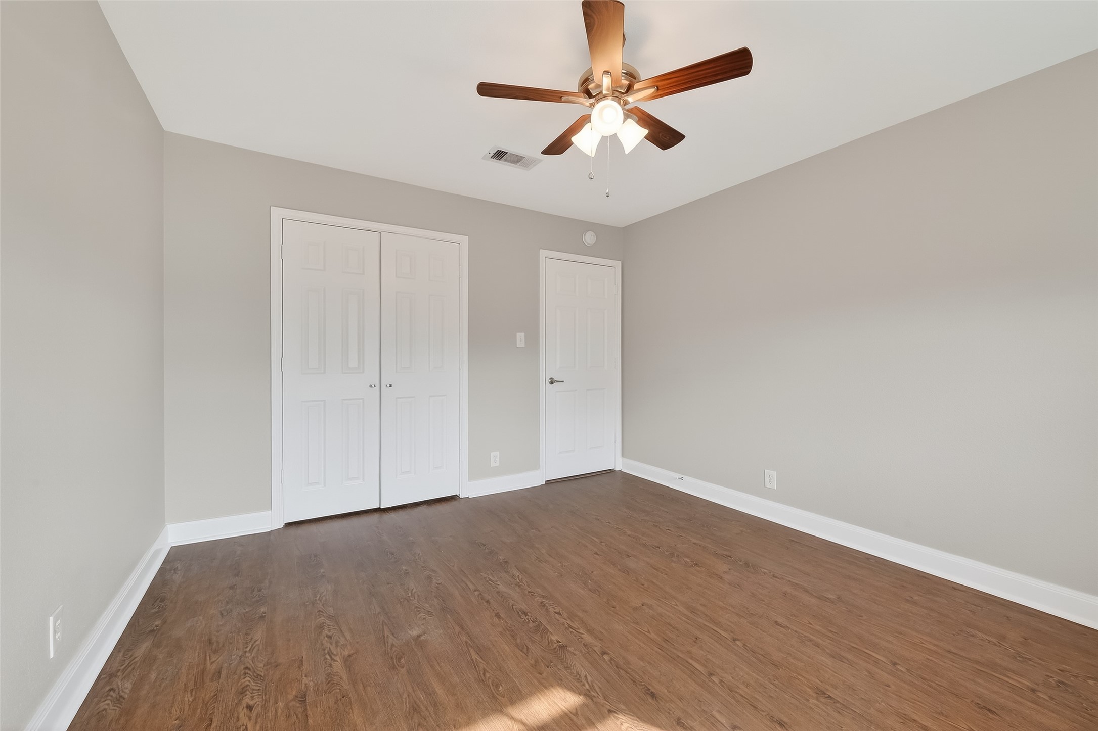 Comfortable secondary bedroom with updated interior finishes and generous closet space.