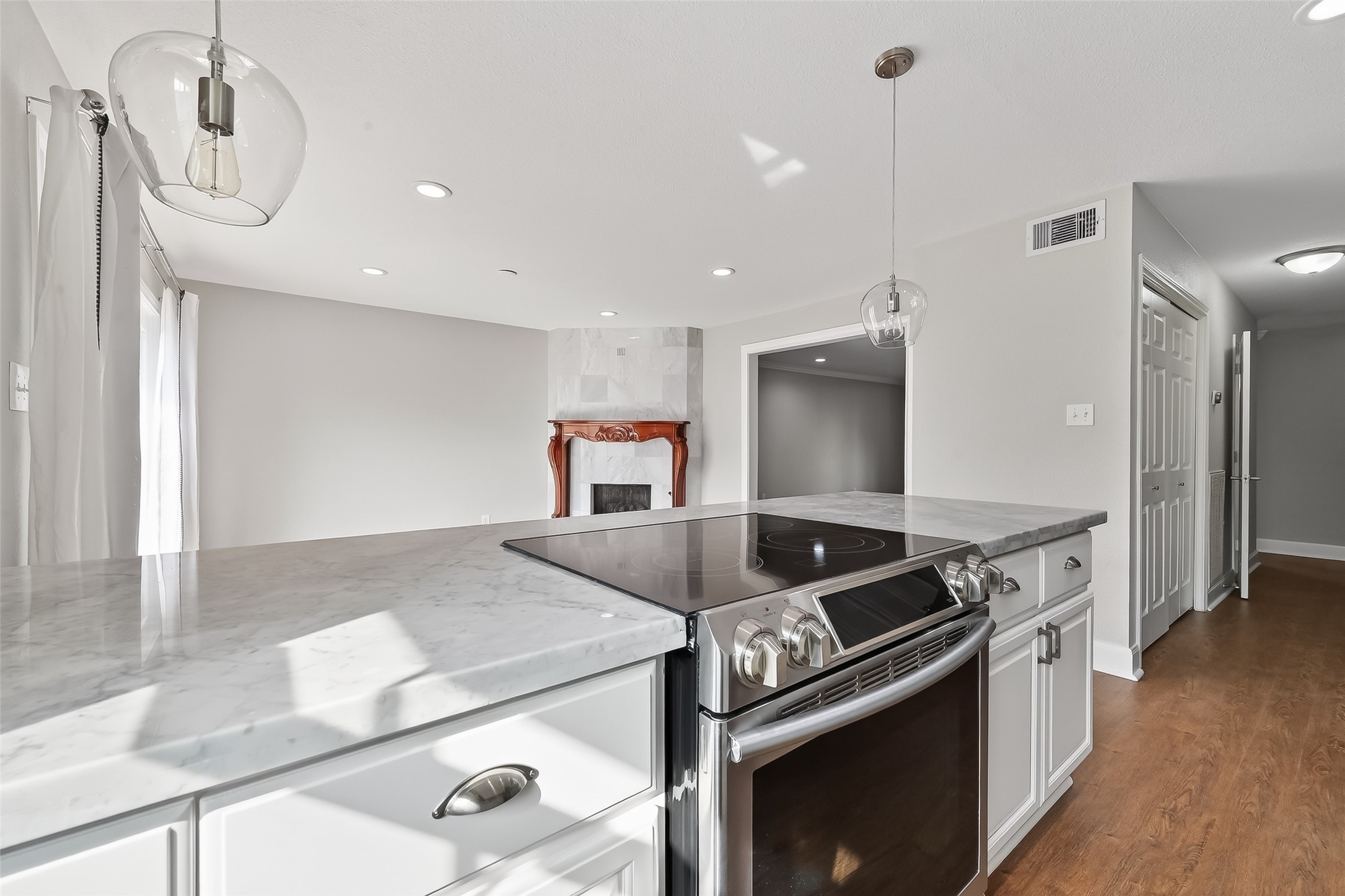 Bright kitchen with updated cabinetry, stainless steel appliances, and open flow to the living and dining spaces.