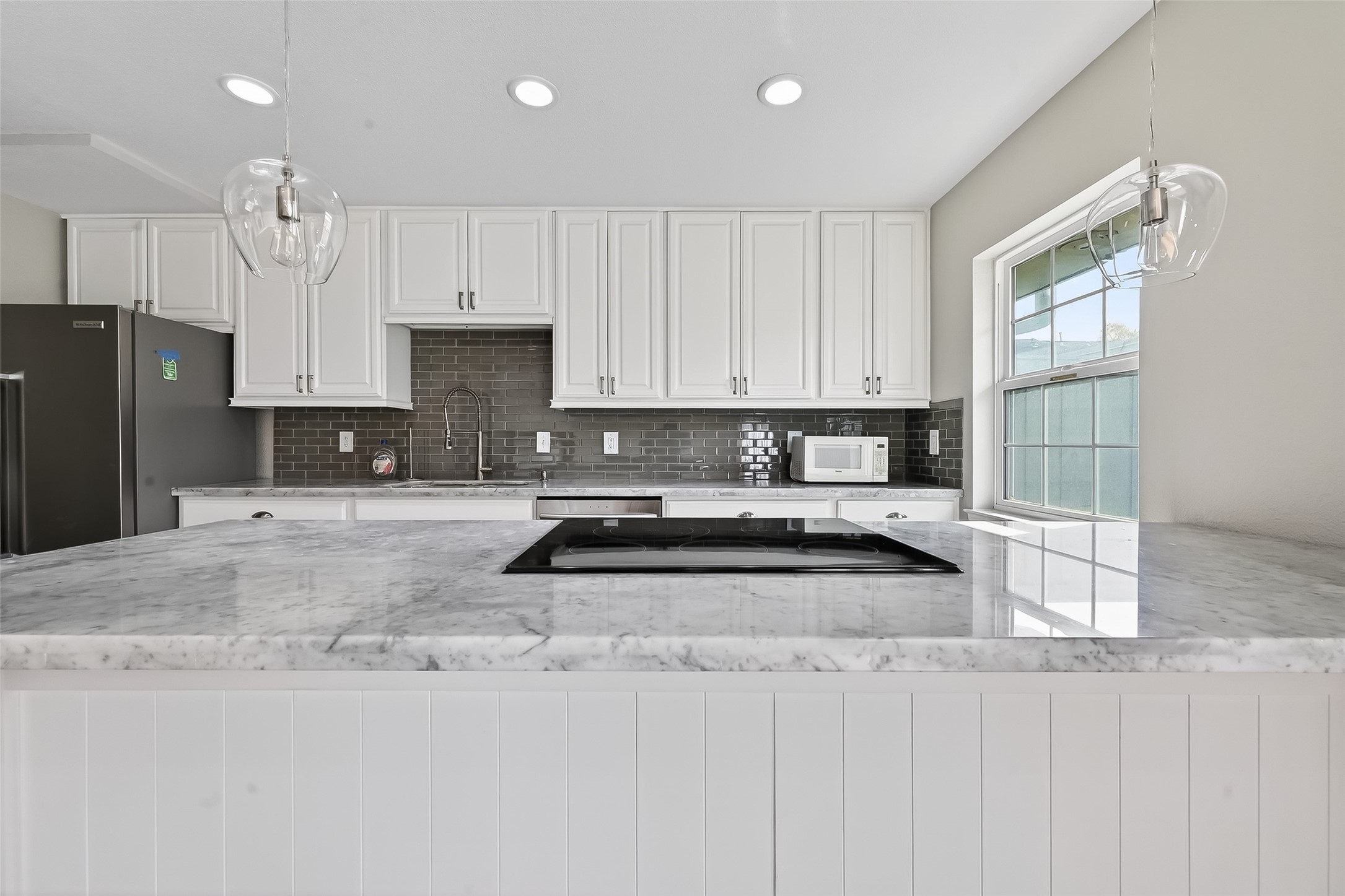 Modern Houston townhome kitchen with Carrera marble counters, designer finishes, and functional layout for everyday living.