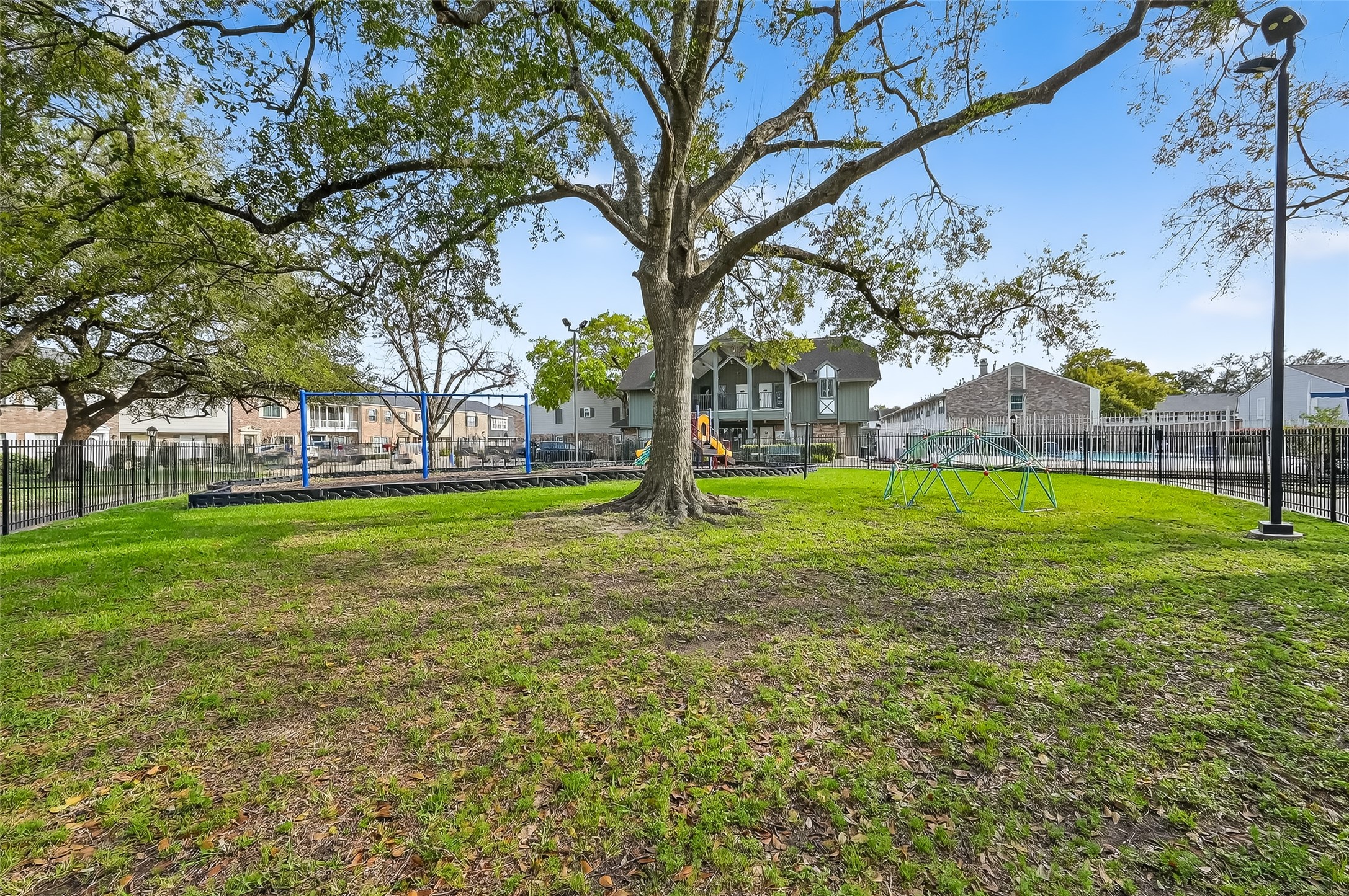 Neighborhood playground and green space within the Briar Grove Townhome community in Houston.