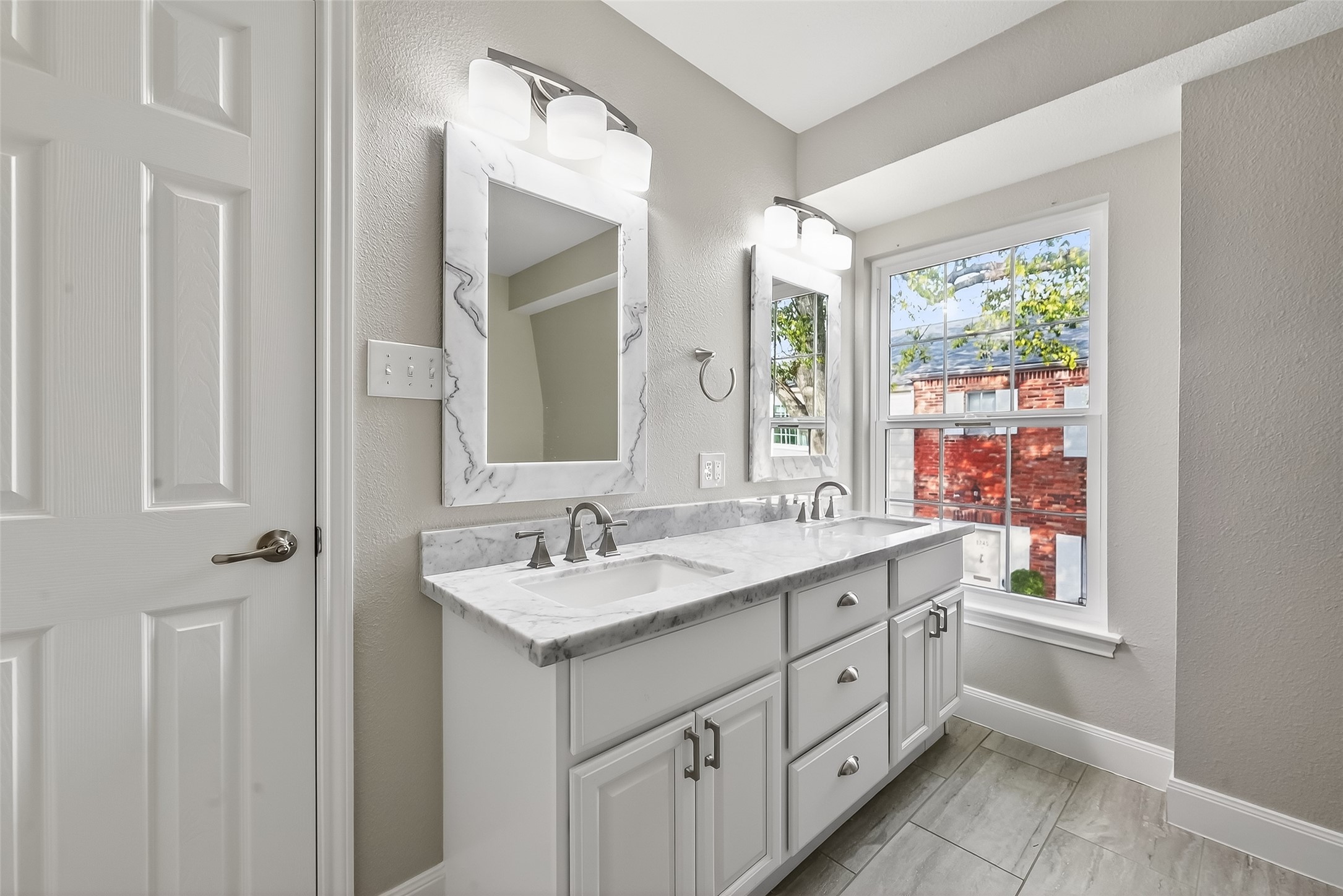 Renovated primary bathroom with luxurious walk-in shower and custom finishes in this Briar Grove townhome.