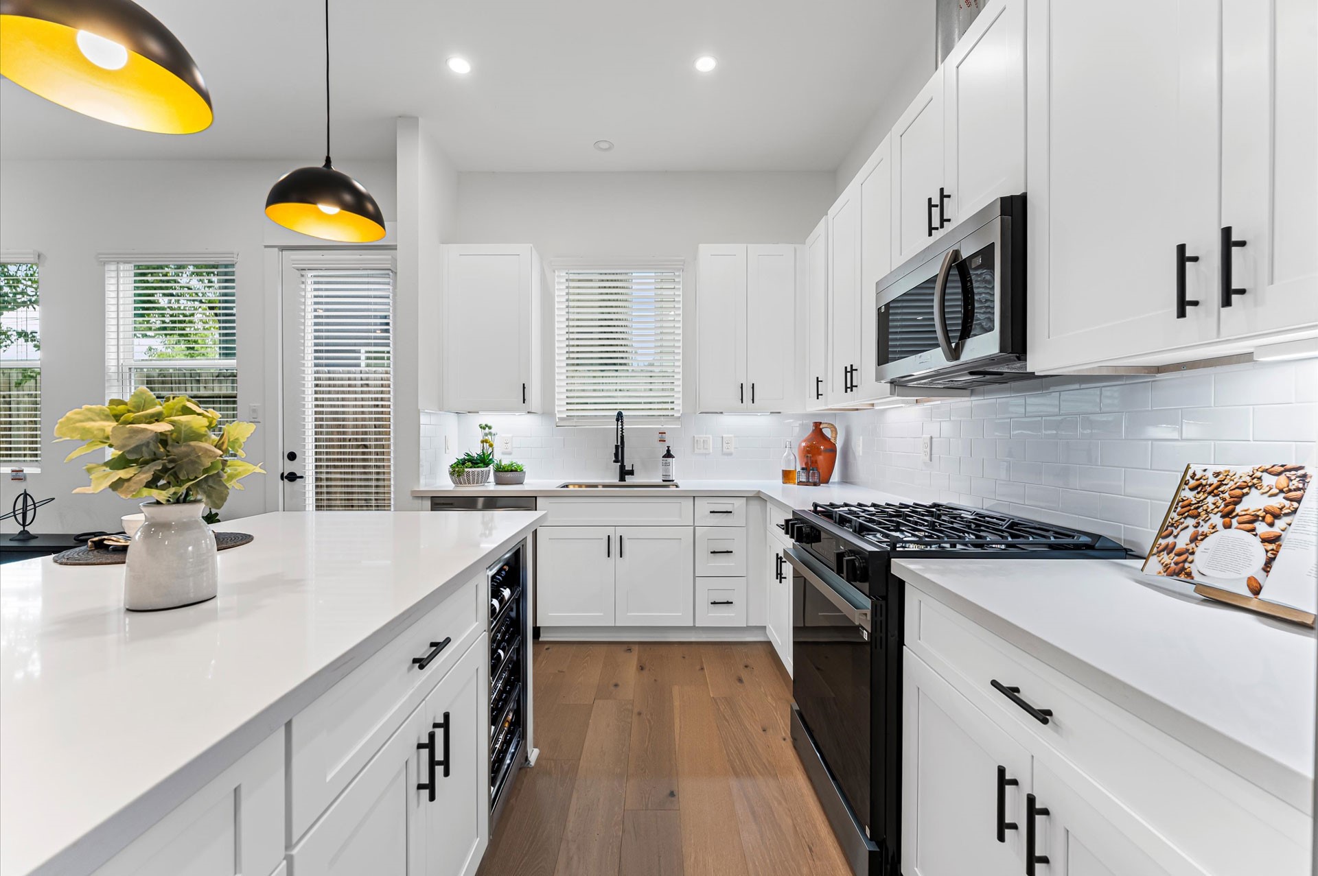 This stylish kitchen showcases plenty of sleek cabinetry, thoughtfully arranged to maximize storage and enhance the rooms modern aesthetic. Upper and lower cabinets feature clean lines and minimalist hardware, blending seamlessly with the spaces design. Integrated appliances and under-cabinet lighting add both function and flair, while the layout easy access and efficient organization. Ideal for culinary enthusiasts and entertainers alike, this kitchen combines smart storage with sophisticated style.