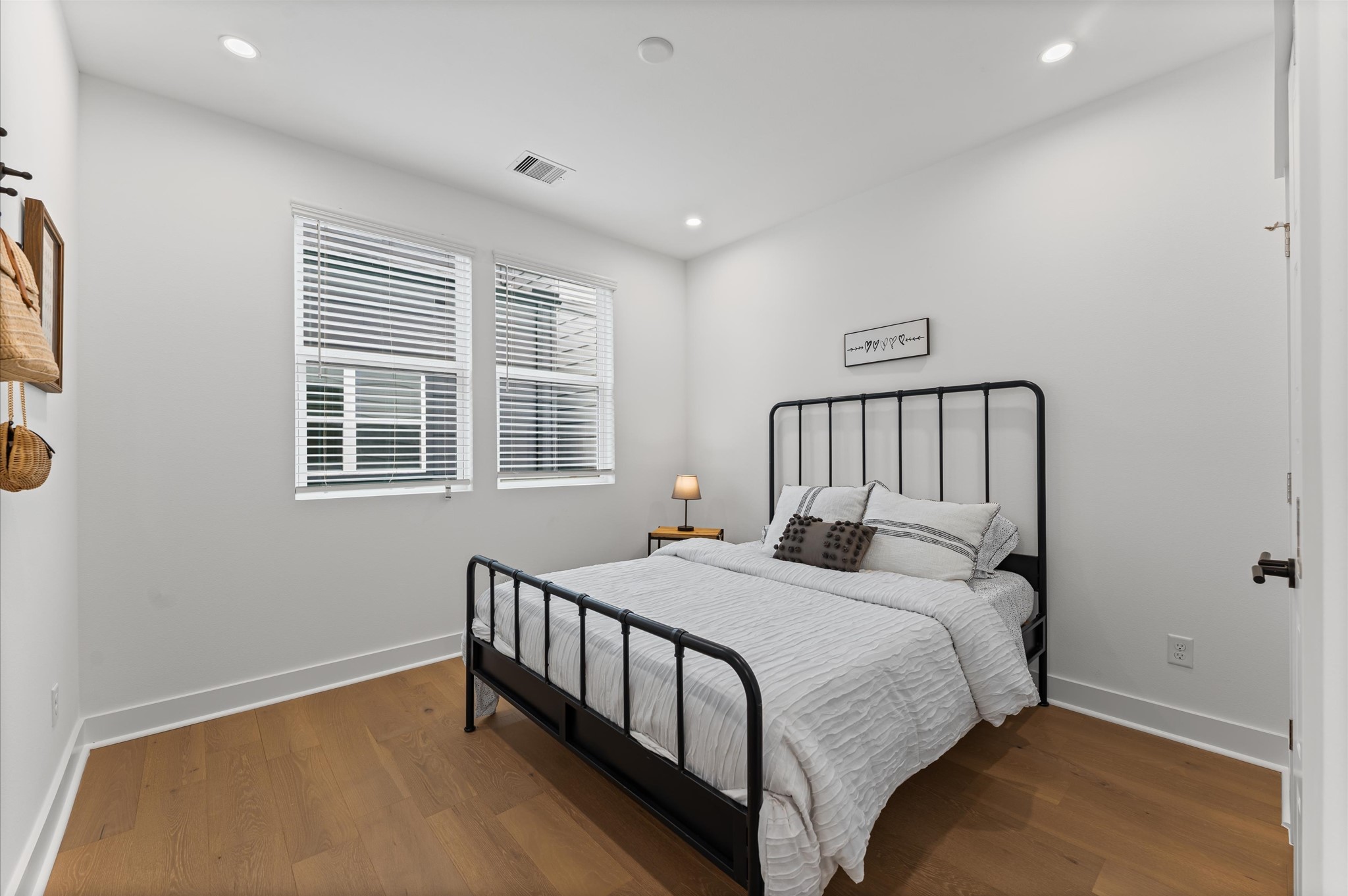 This secondary bedroom on the second floor exudes warmth and sophistication with its rich engineered hardwood flooring, adding a touch of elegance to the space. The smooth, durable surface enhances the rooms clean lines and complements a variety of dcor from cozy and traditional to sleek and modern. Natural light dances across the wood grain, creating a serene atmosphere ideal for rest, work, or creative pursuits.