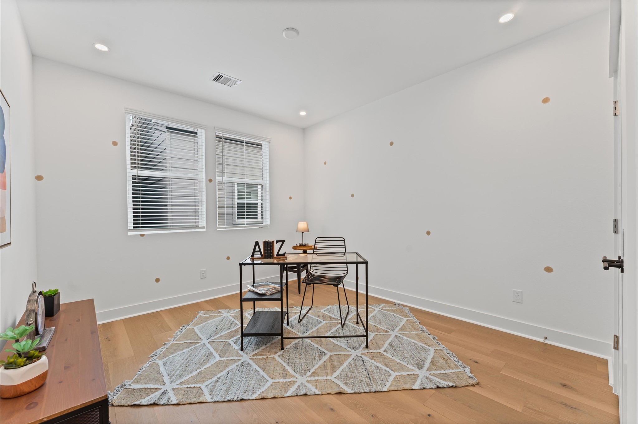 This versatile secondary bedroom on the second floor is currently staged as a stylish home office, featuring a sleek desk setup, ample natural light, and minimalist dcor that enhances focus and creativity. Its neutral palette and uncluttered layout make it easy to reimagine, whether as a cozy guest room, a serene yoga space, or a vibrant playroom. The rooms flexible design invites endless possibilities, adapting effortlessly to suit changing needs and lifestyles.