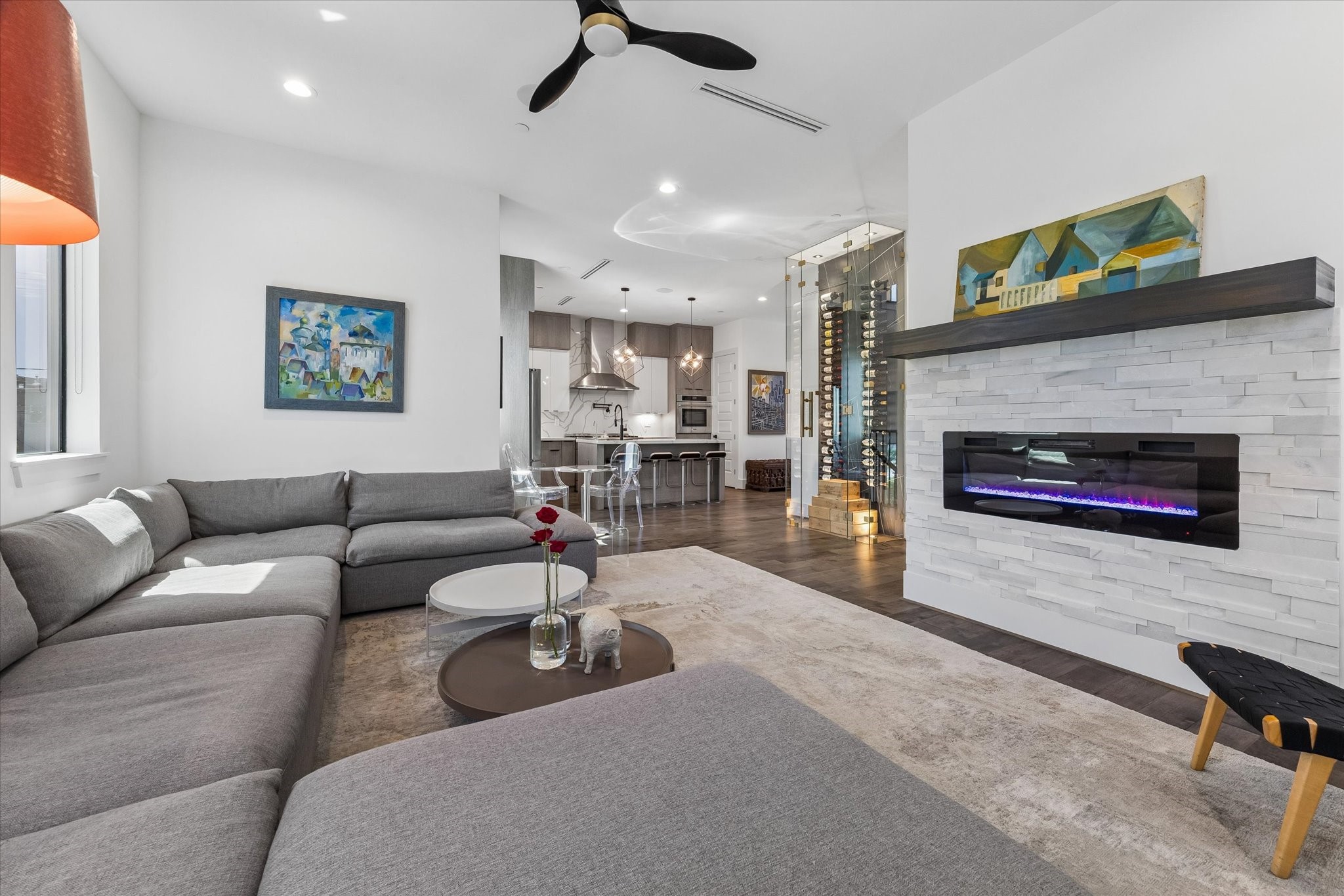 The living room featuring a modern fireplace, open layout, and stylish finishes.
