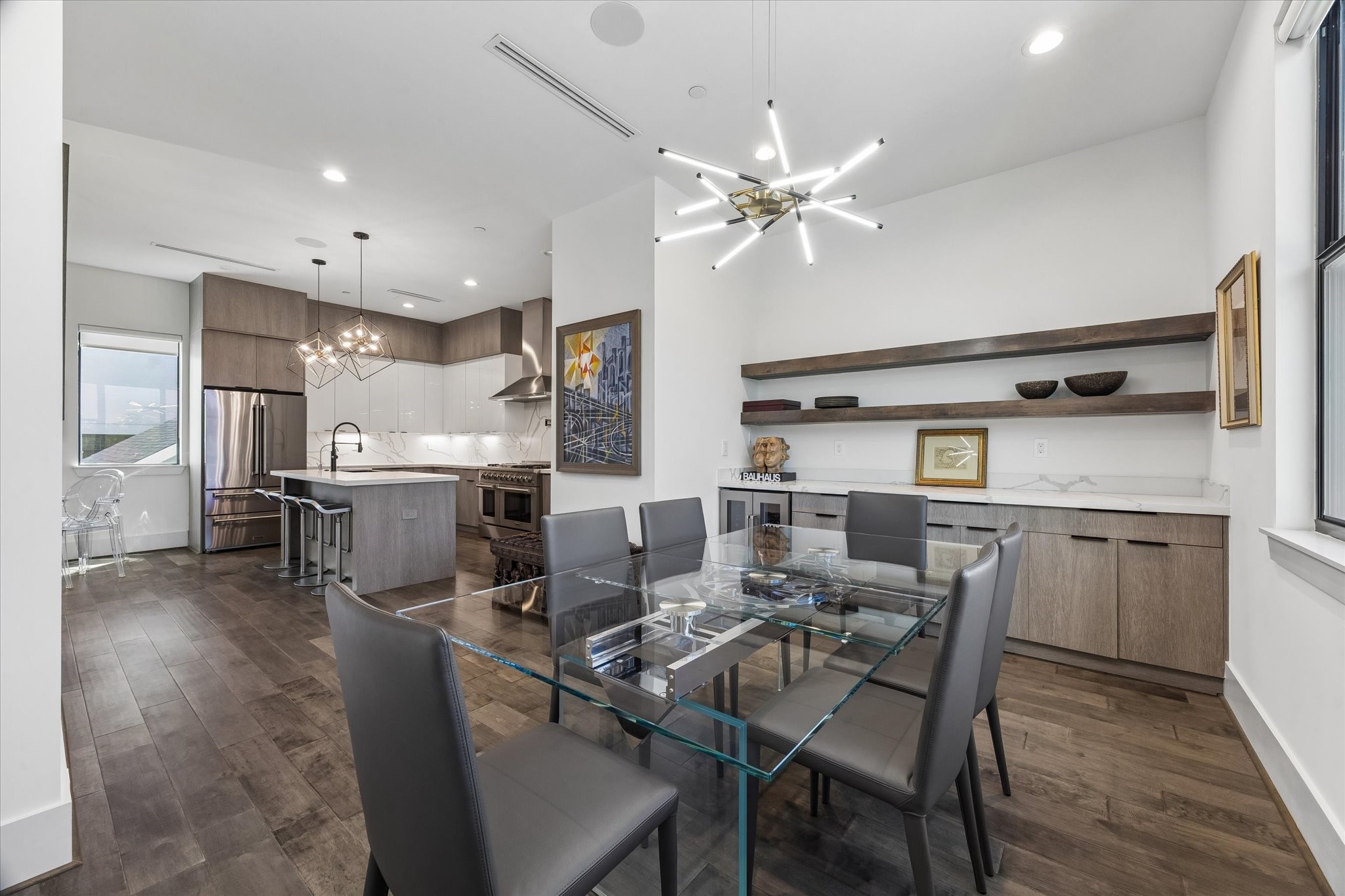 The dining area with stylish shelving, is seamlessly connected to the kitchen.