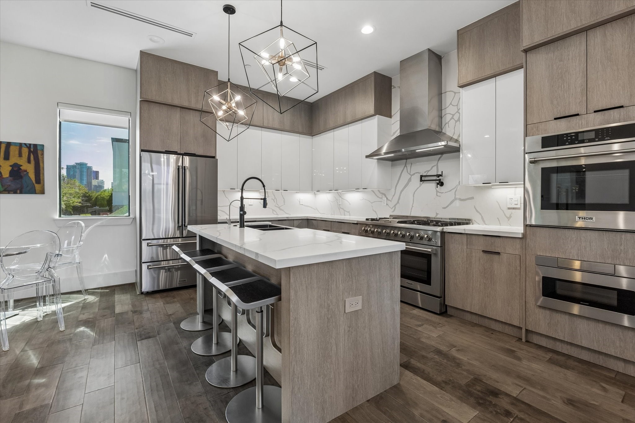 Sleek, modern kitchen with elegant fixtures, a spacious island, and open layout.