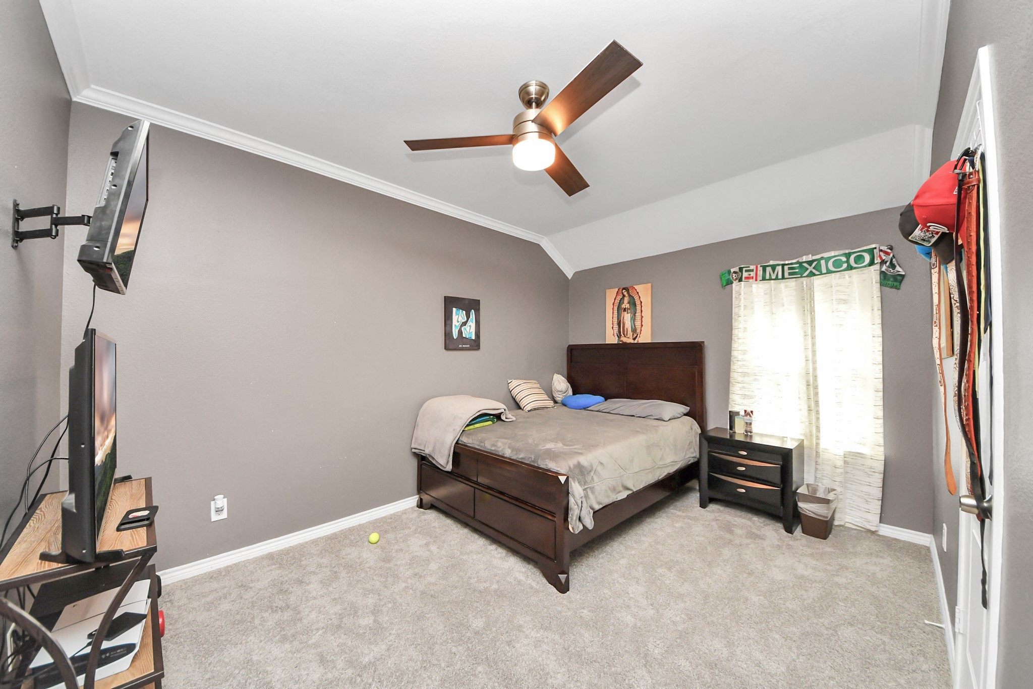 Additional bedroom with a ceiling fan and window light.