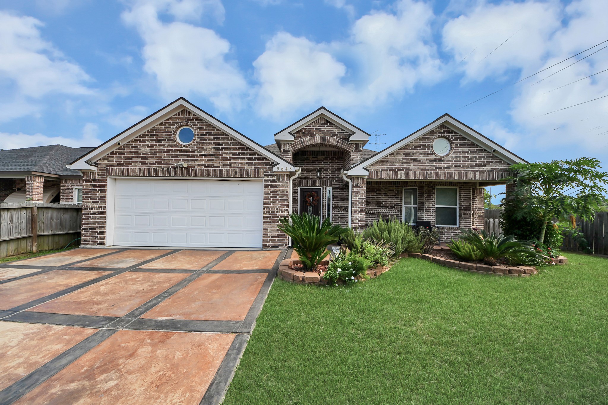Brick exterior and covered entry at 9645 Ashville Drive, Houston.