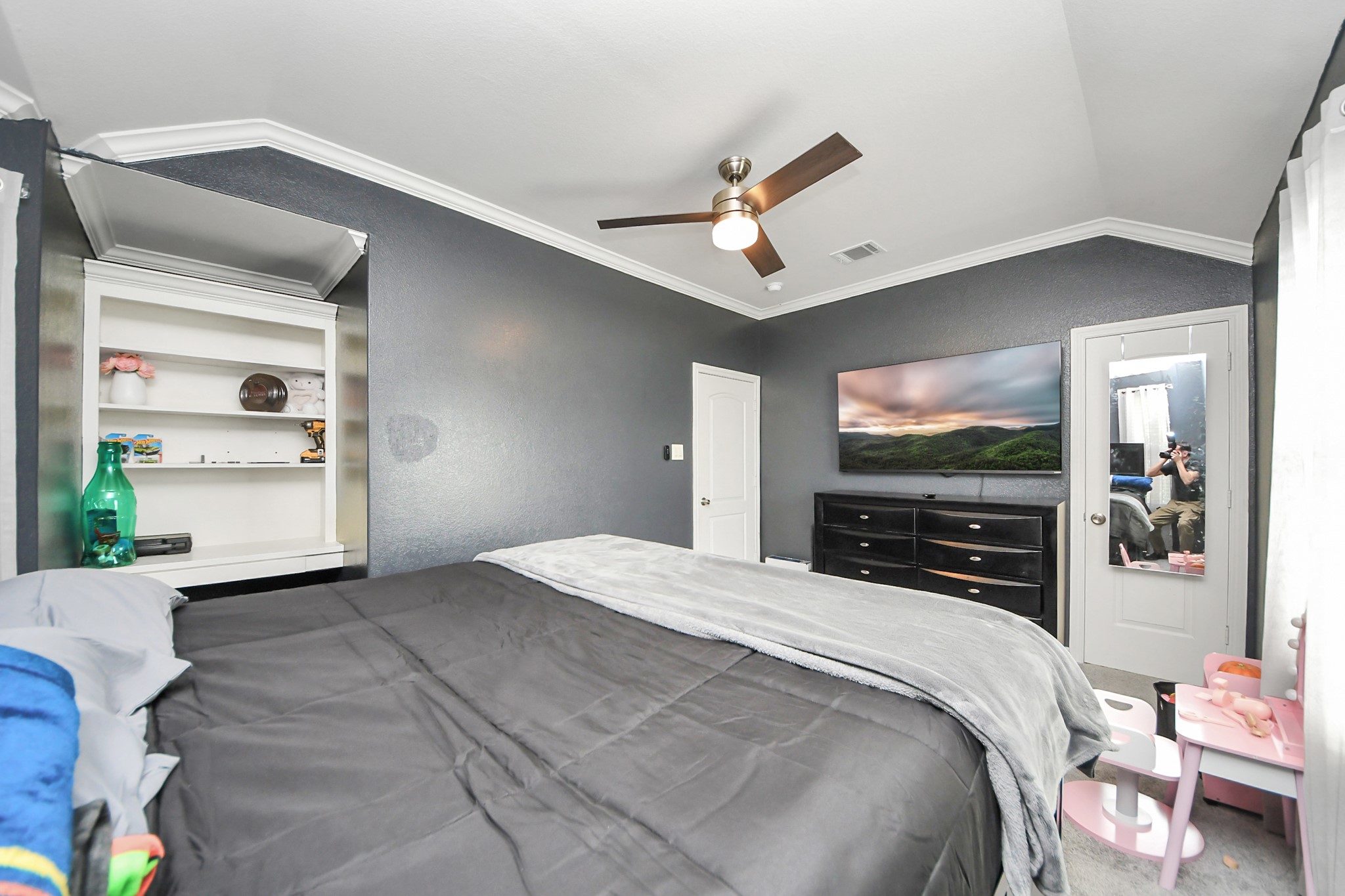 Another bedroom view shows the windows and ceiling detail.