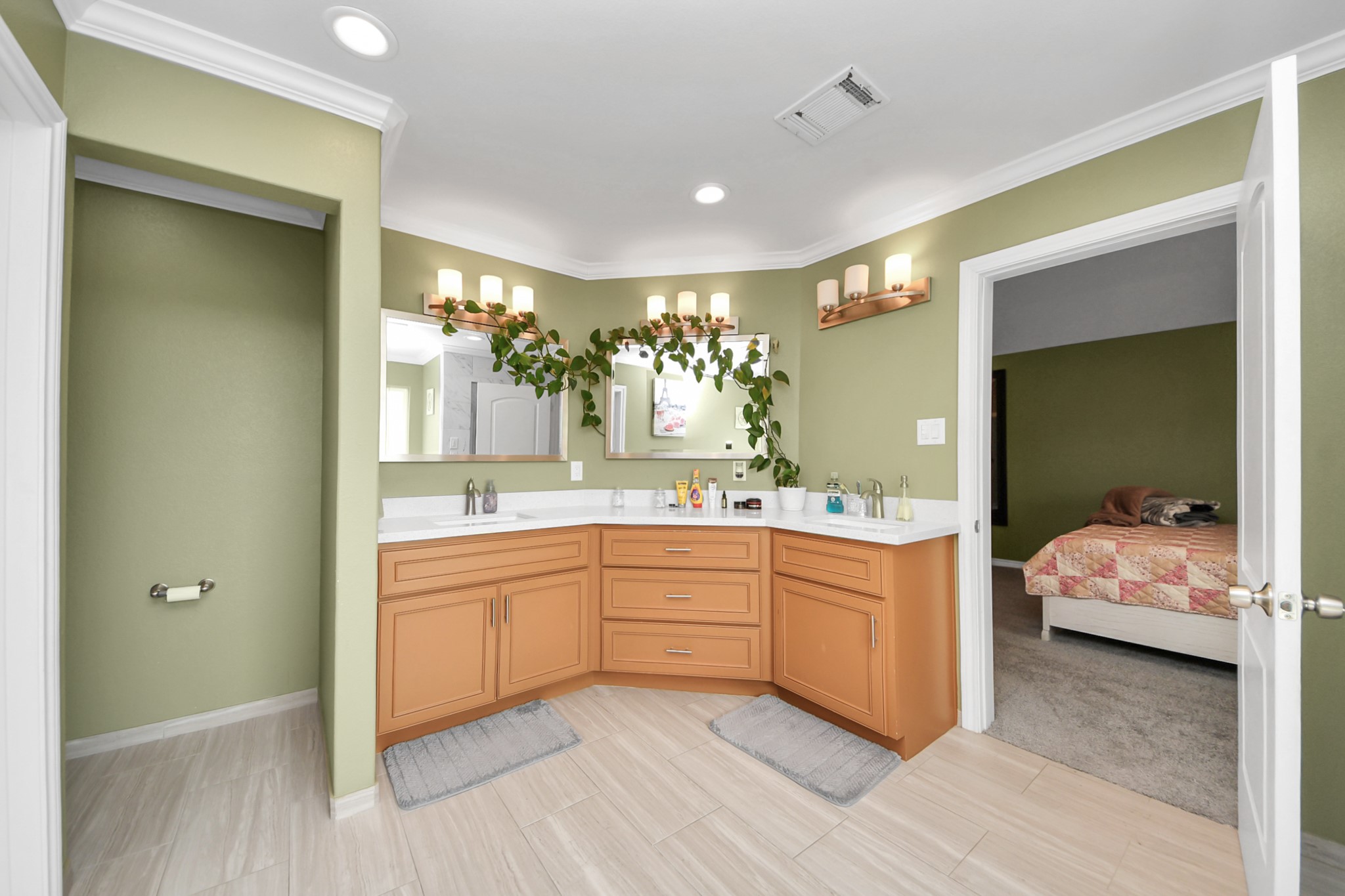 Dual-sink vanity with wood cabinetry in the primary bathroom.