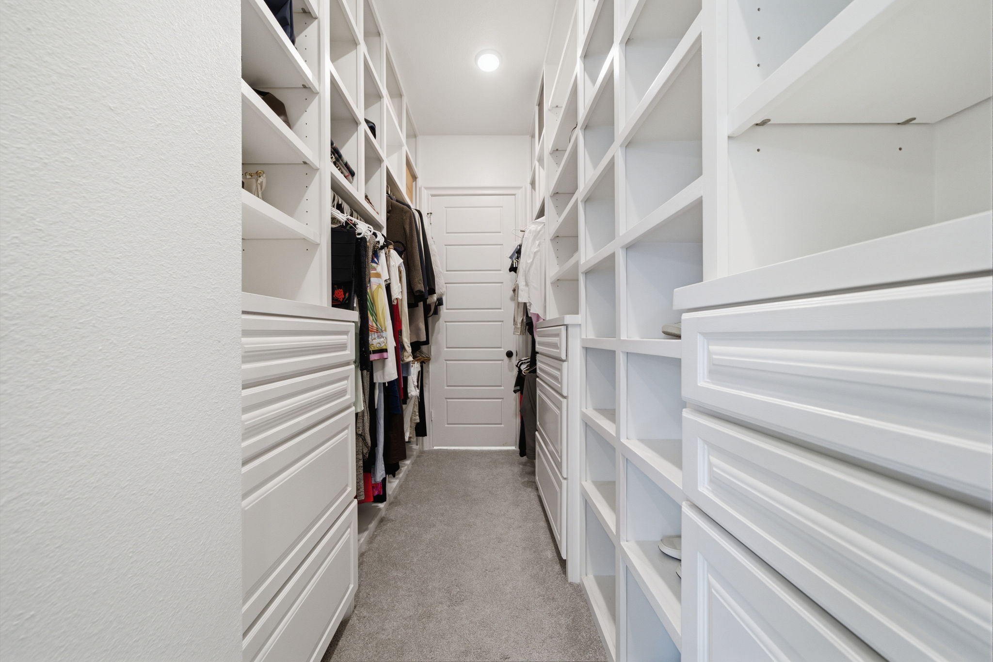 Spacious walk-in closet featuring abundant shelving and storage solutions for organized living.