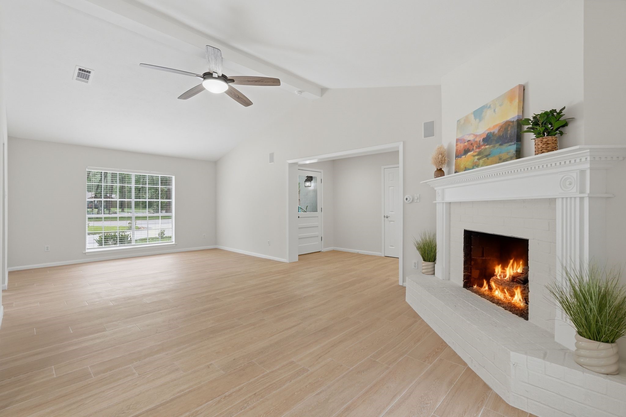 Now let's continue through and look at your massive living room with vaulted ceilings, a cozy fireplace, and multiple seating areas.