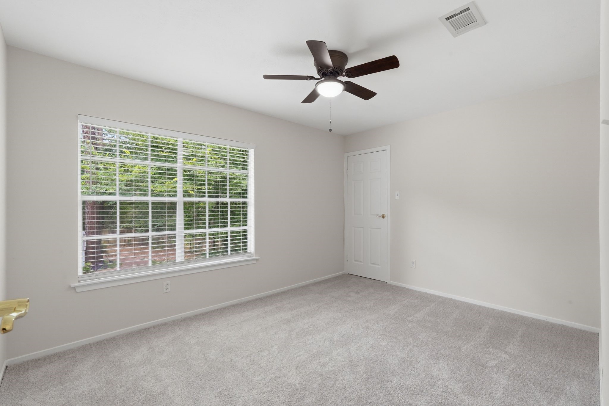 At the top of the stairs to the left, you'll see another secondary bedroom with its own walk in closet too and large windows.