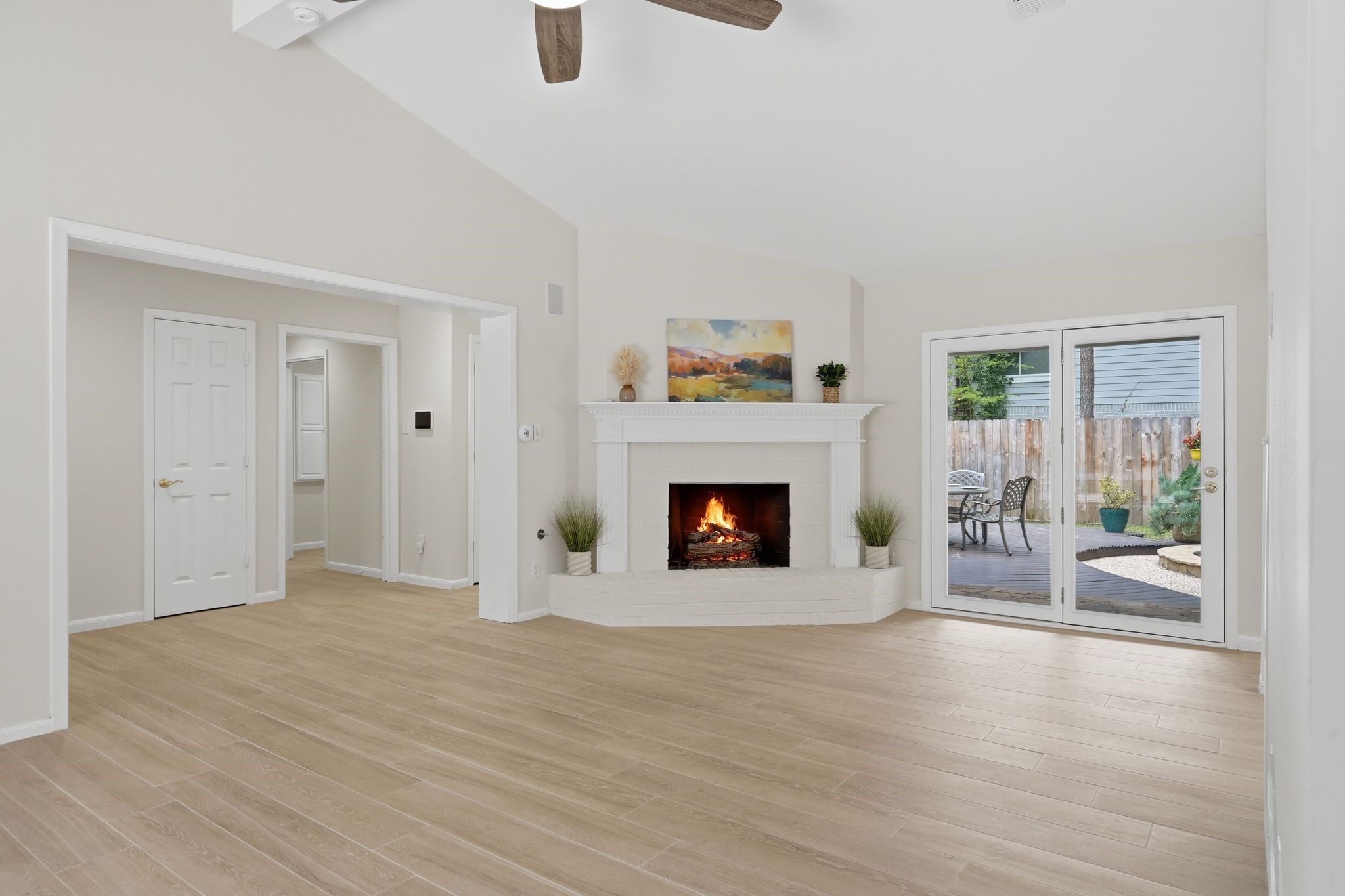 From this view you can see through the door on the left the hallway to your primary bedroom, laundry room, and another entrance to your backyard.