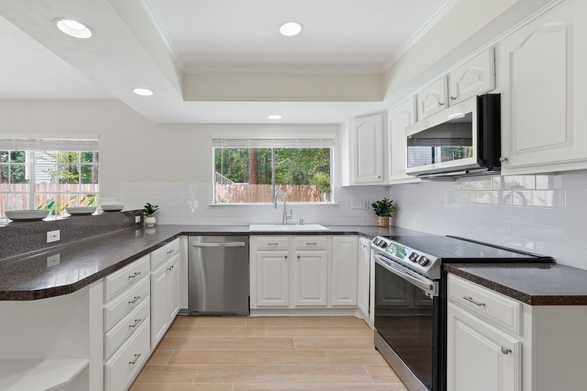 Notice the fresh paint and backsplash in the kitchen and all the natural light in this space.