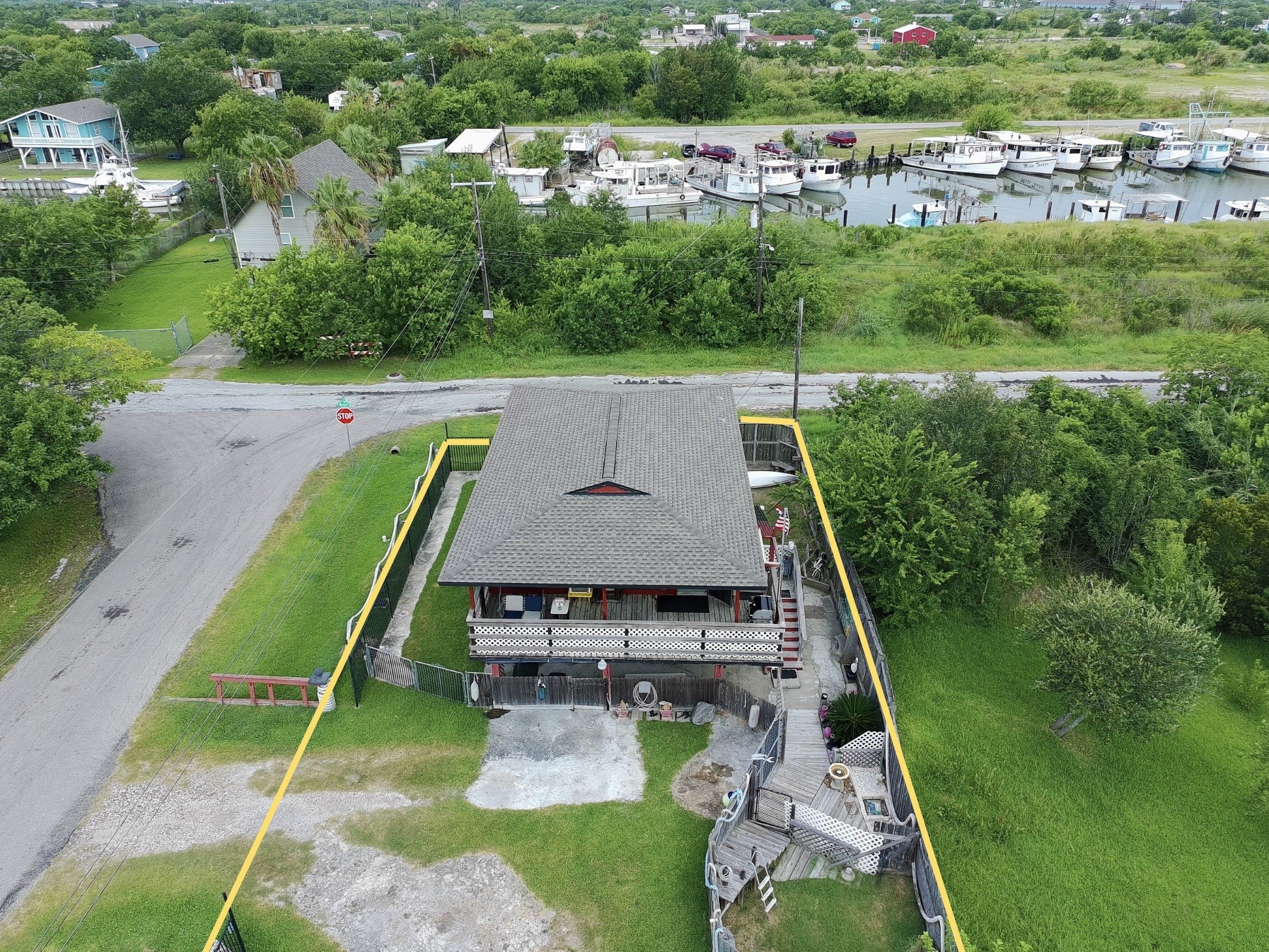 overhead view shows proximity to water (red house) (yellow boundary lines are approximate, refer to provided survey)