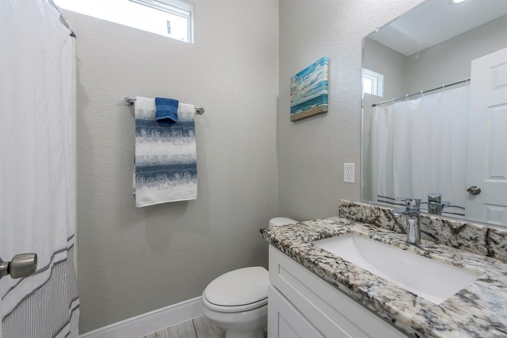 Bathroom with granite countertop, & undermount sink.