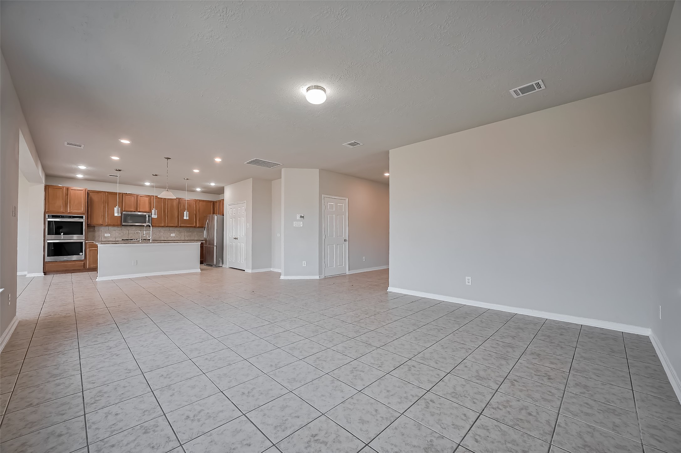 living room features tile flooring and neutral walls. living room features tile flooring and neutral walls.