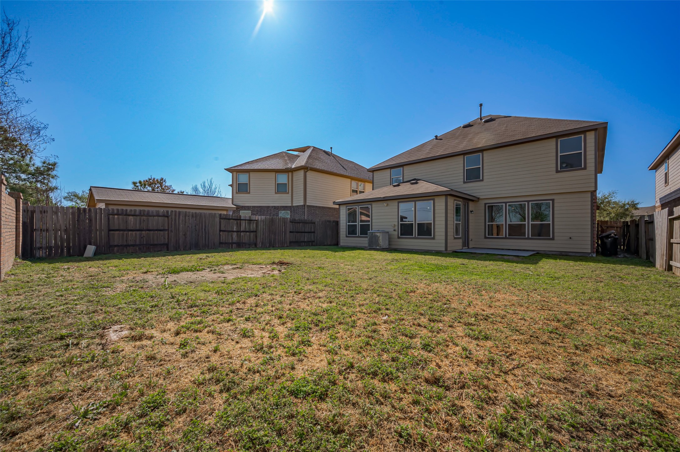 Backyard featuring a fenced perimeter & well-maintained lawn.