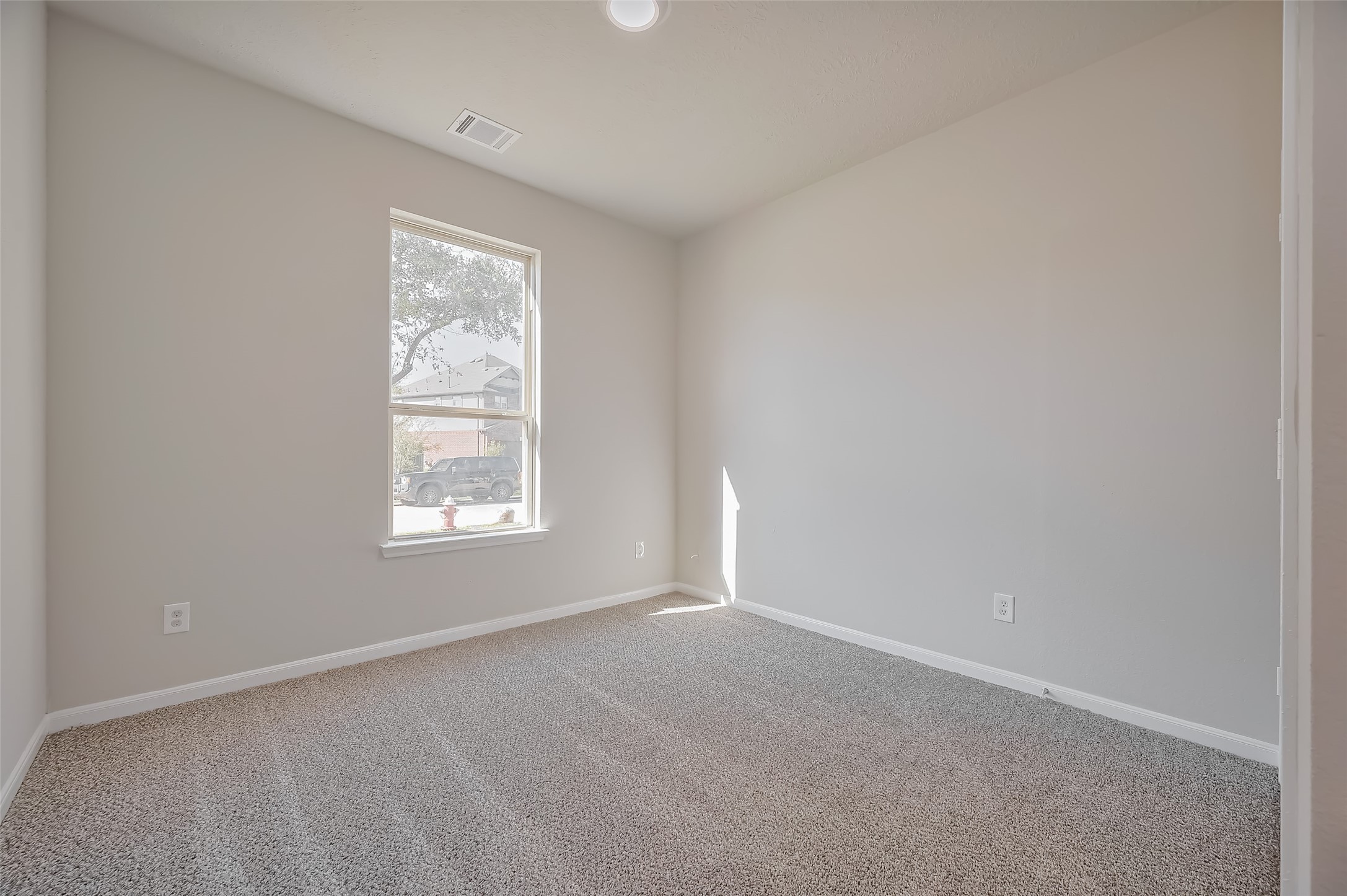 Bedroom features carpet floor and a window.