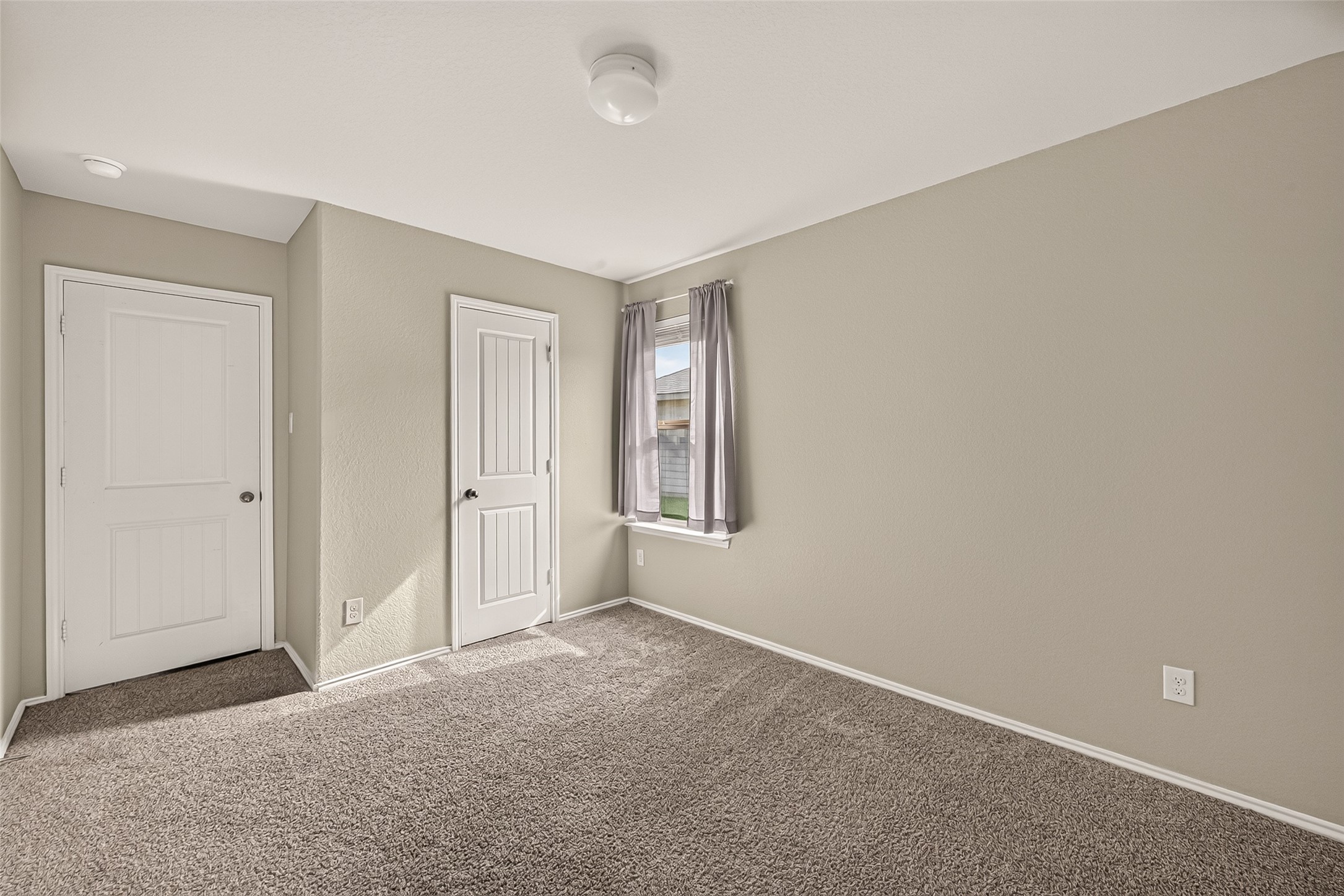 Big windows and carpet throughout the secondary bedrooms.