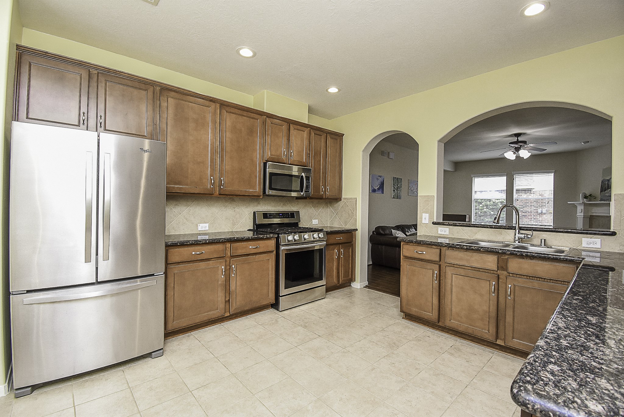 Modern recessed lighting illuminates the open kitchen.