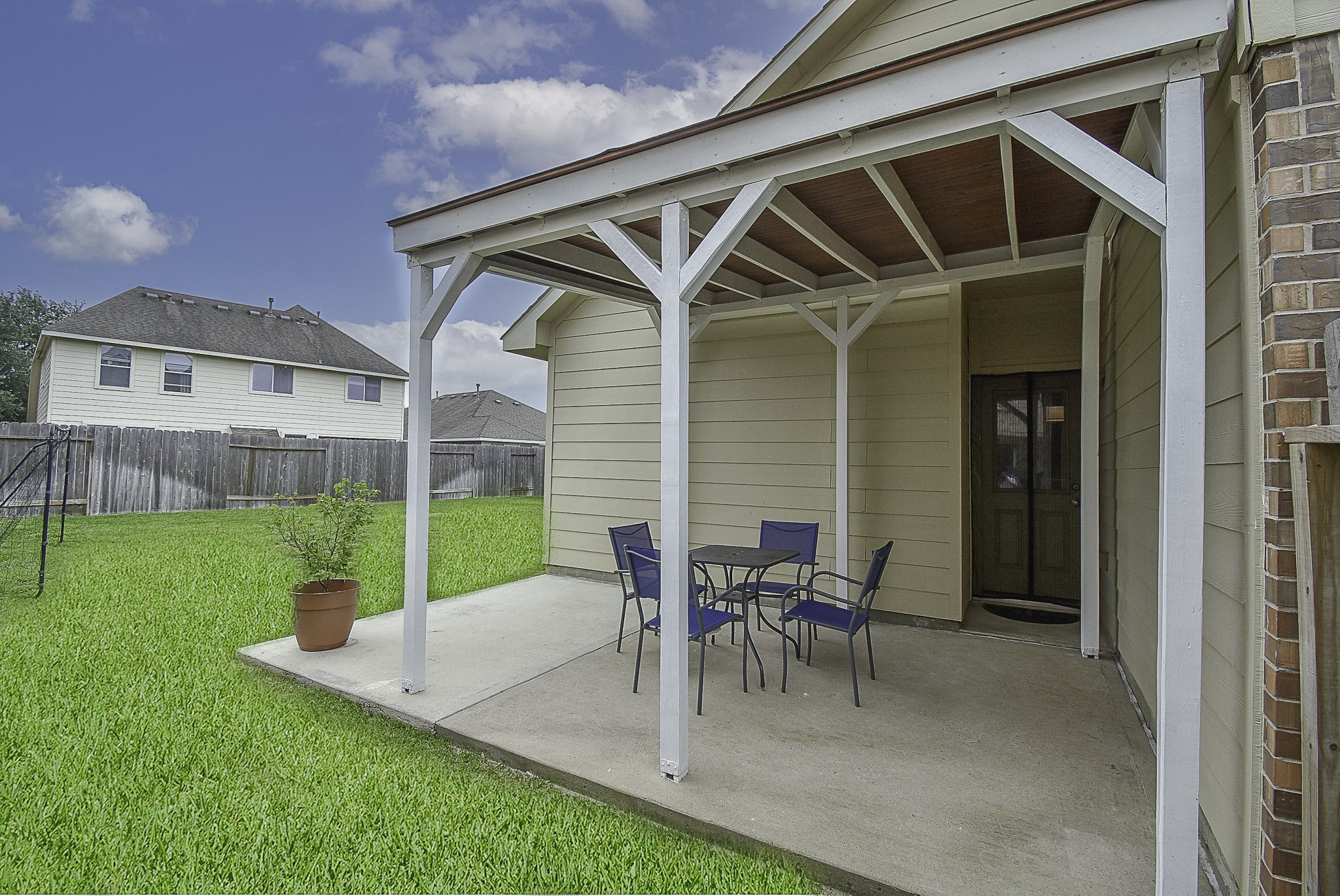 Elegant covered back patio in the huge backyard.