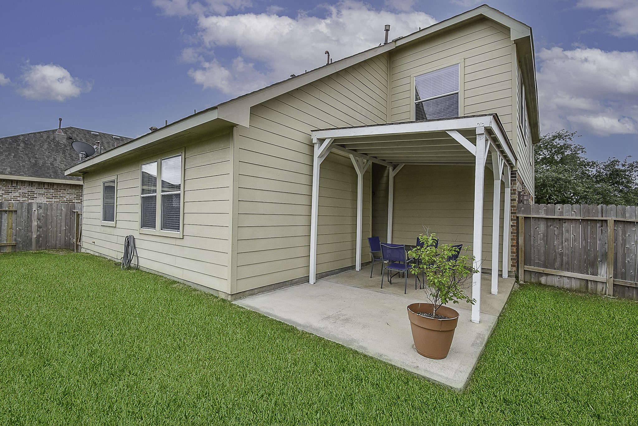 Relax under the convenient covered back patio overlooking the backyard.