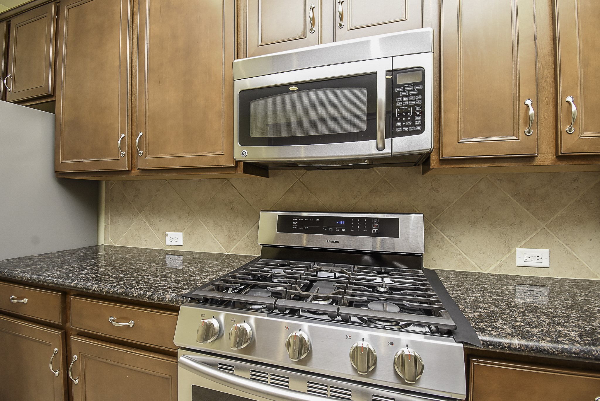 View of the stainless steel appliances and abundant counter space.