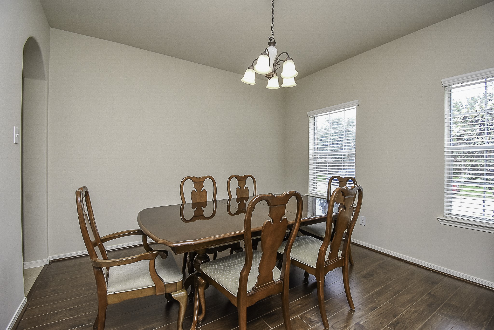Natural light fills the room, while a traditional chandelier completes the space.
