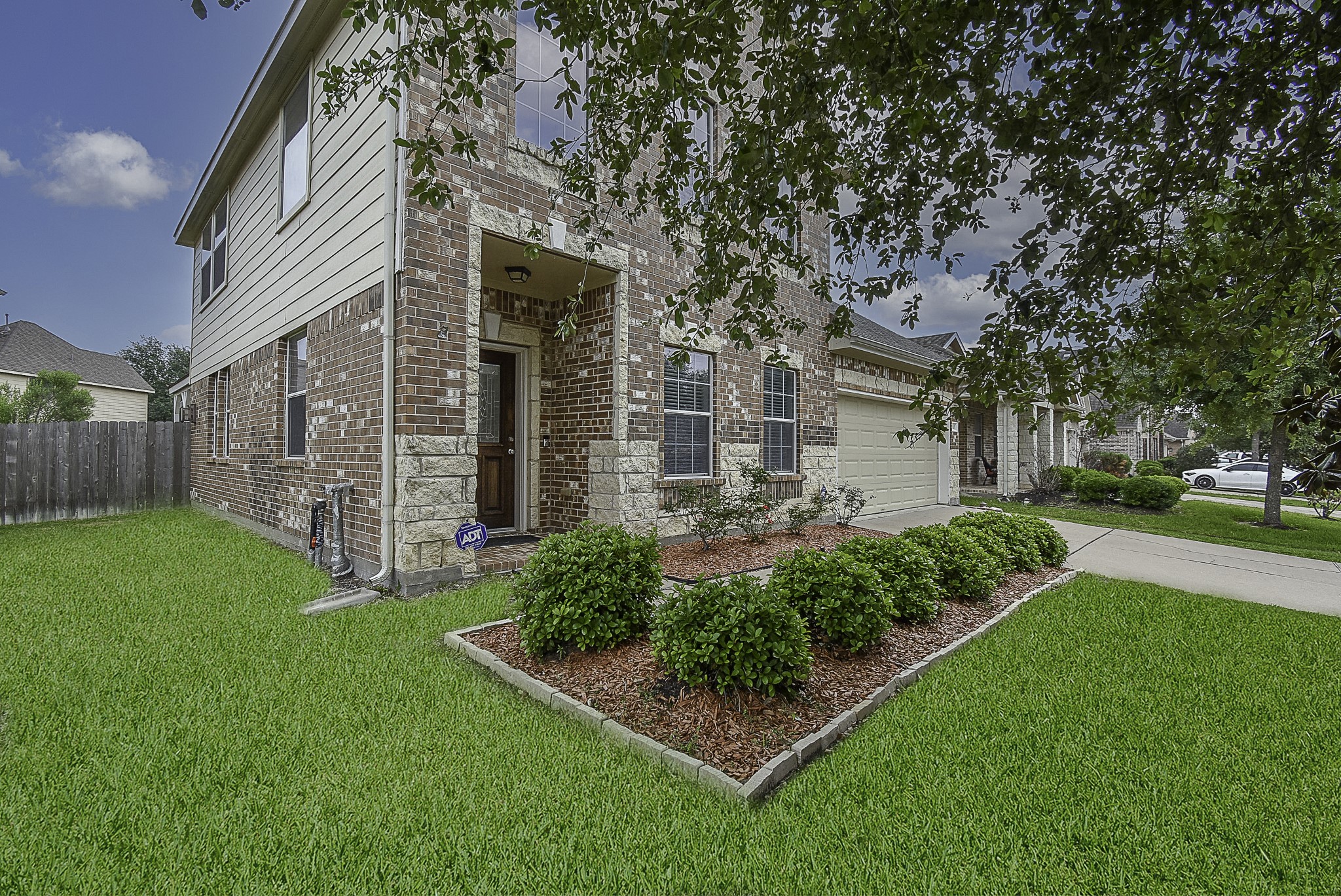Stone, brick and vinyl siding come together to create captivating curb appeal.