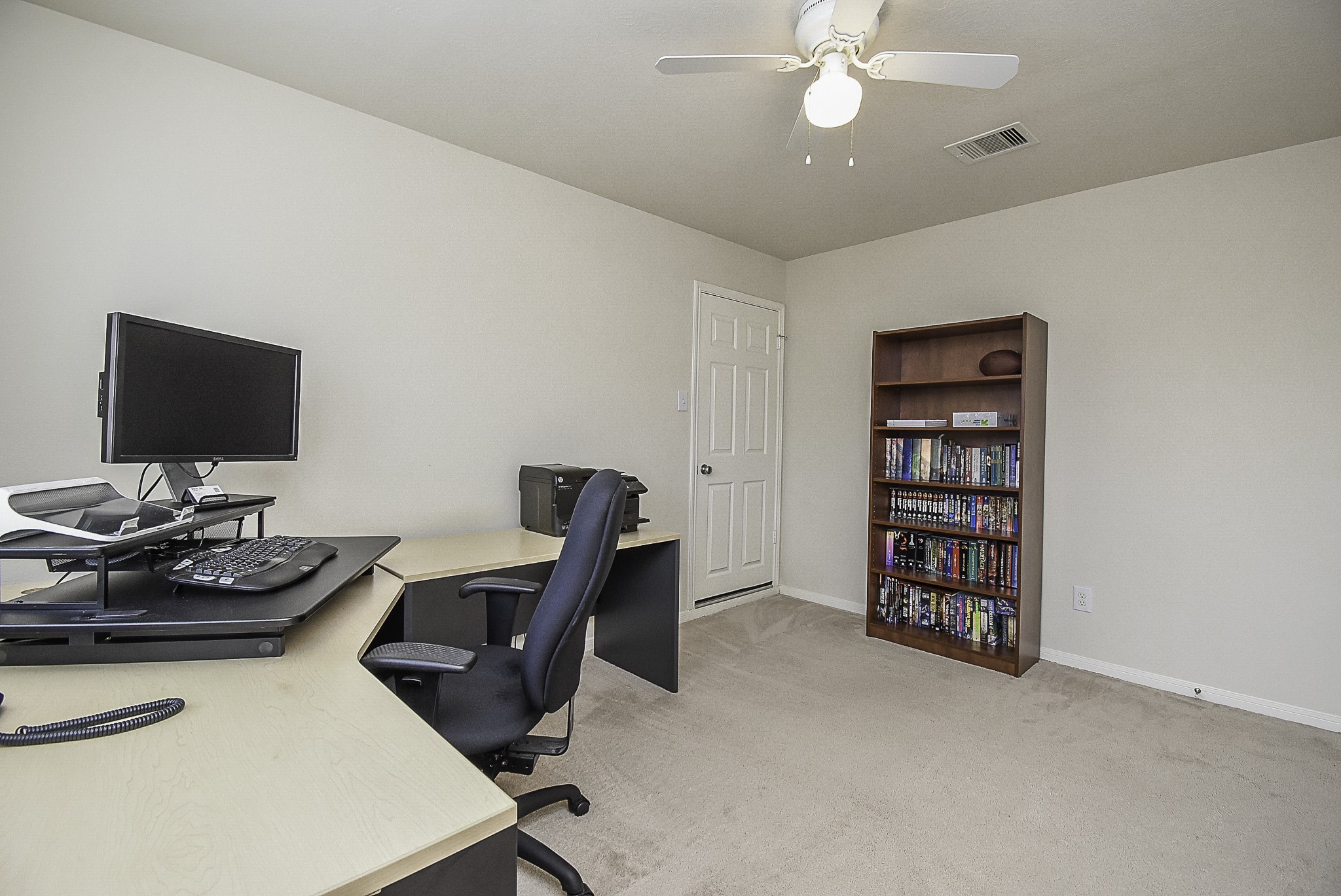 Spacious third bedroom with a ceiling fan and plenty of room to make the space your own.