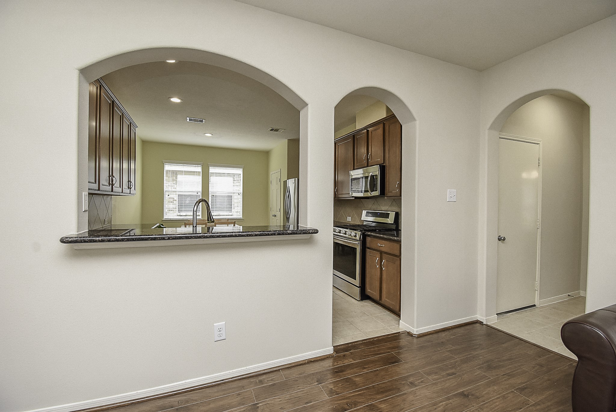 Breakfast bar with a well-placed passthrough window peering into the kitchen.