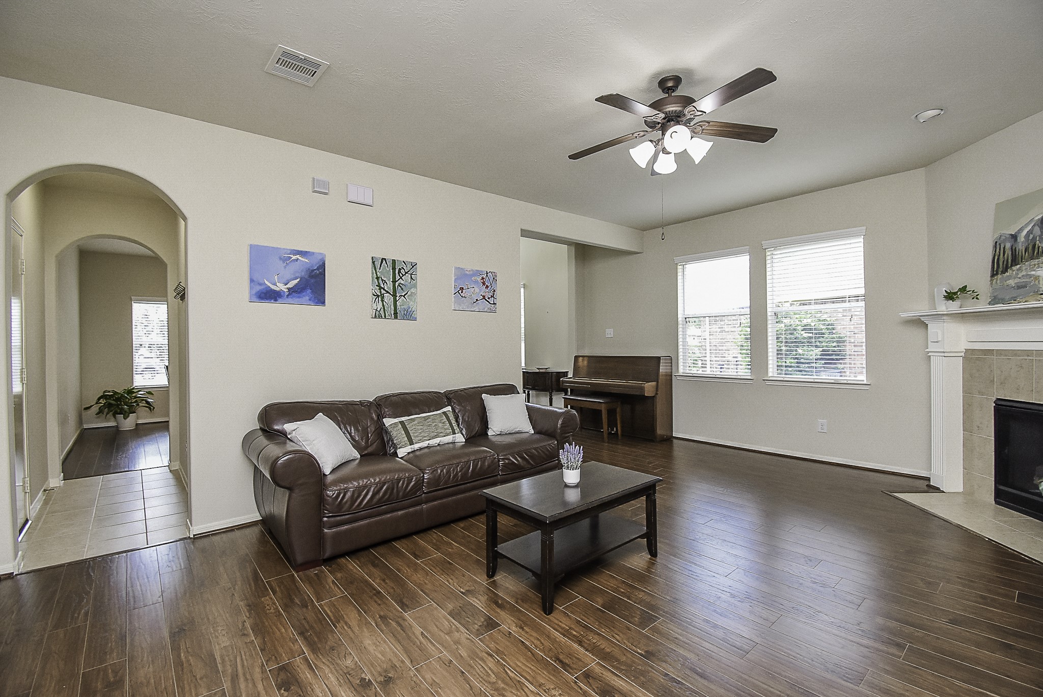 Unwind in the expansive living room, complete with a ceiling fan and plenty of natural light.