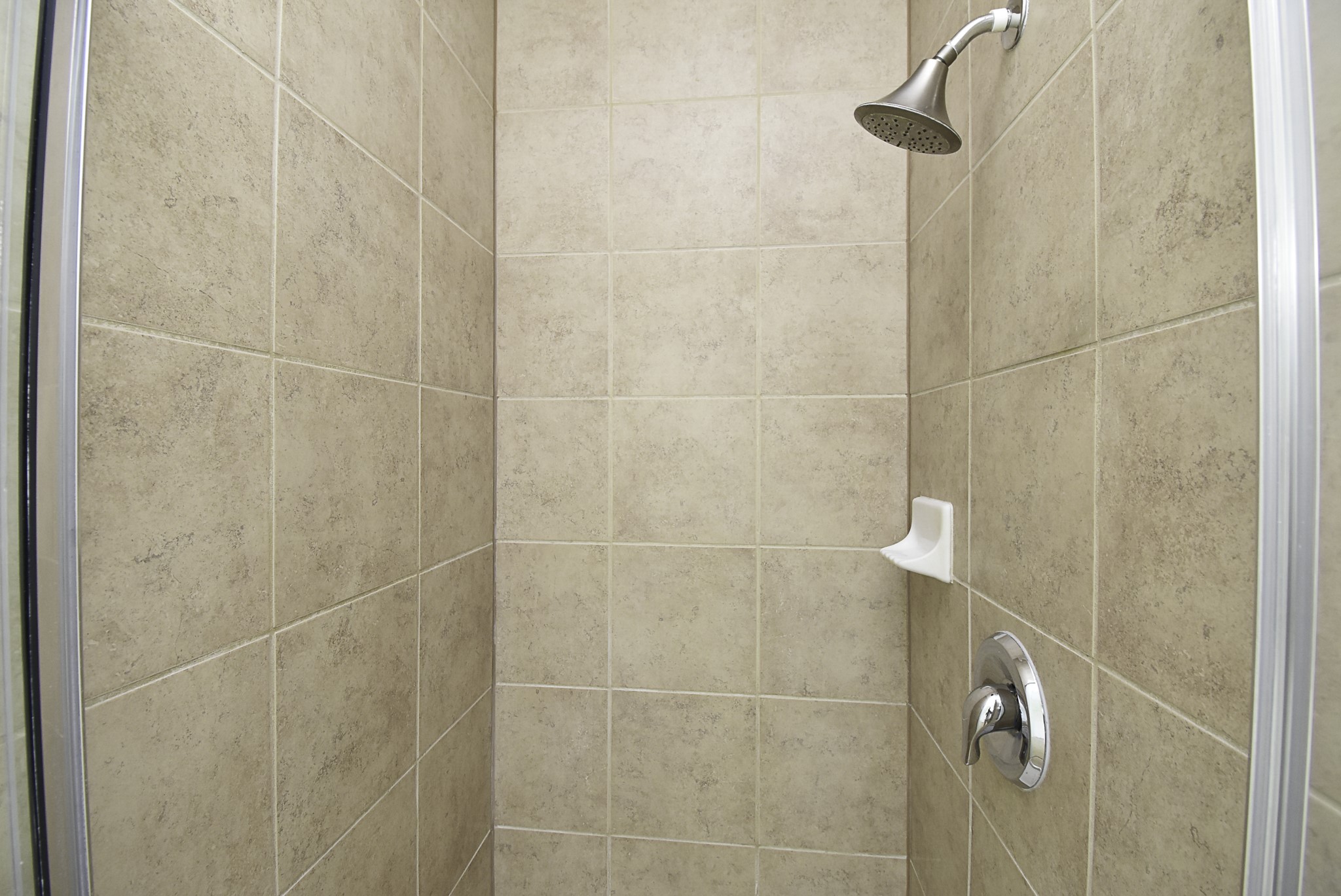 A closer view of the tiled walk-in shower.