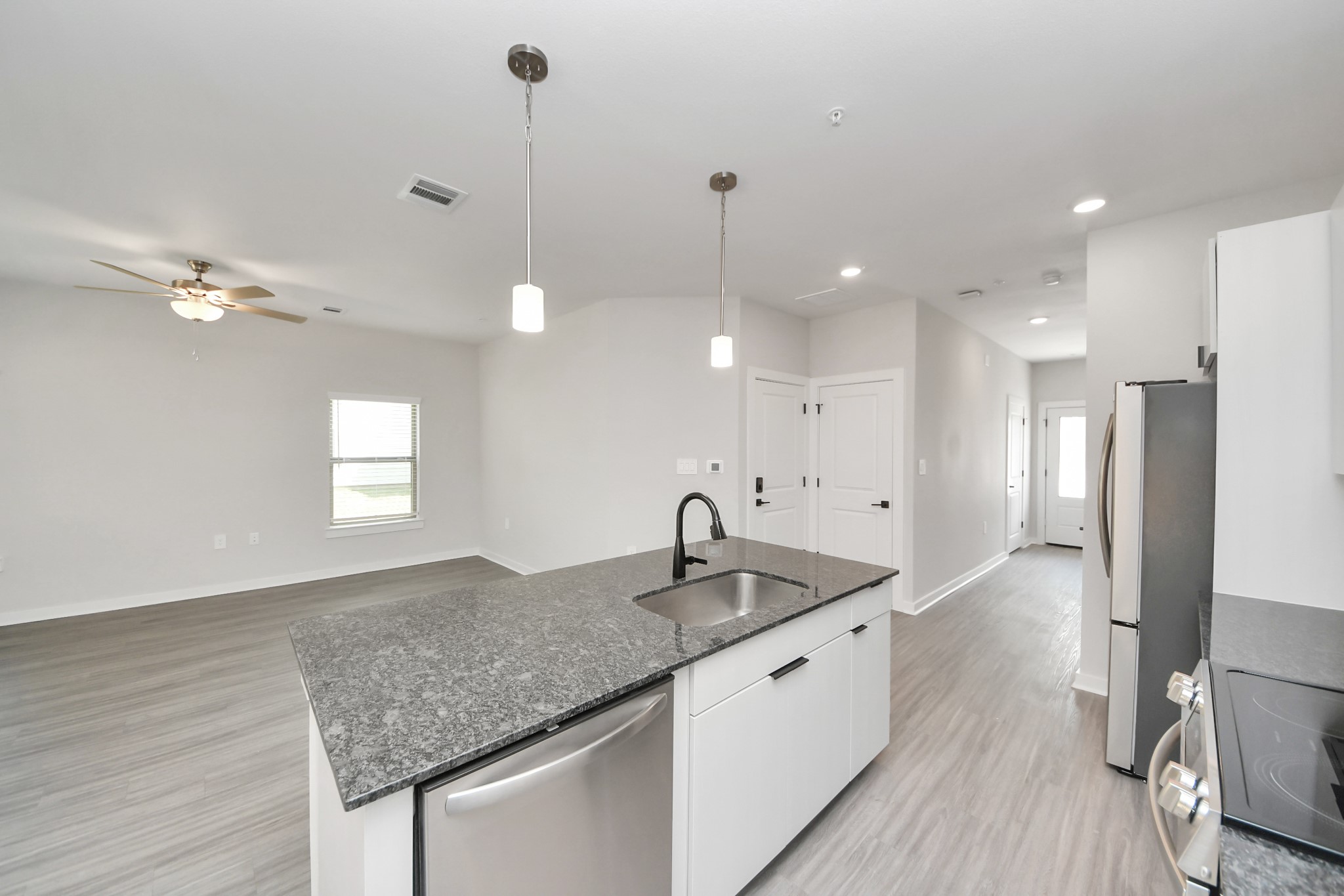 Boasting luxury finishes-stylish Island kitchen,granite counters,subway tile backsplash,ample custom cabinet space,stainless appliances,refrigerator,full size washer&dryer included,wood-like floors throughout,open concept floor plan.