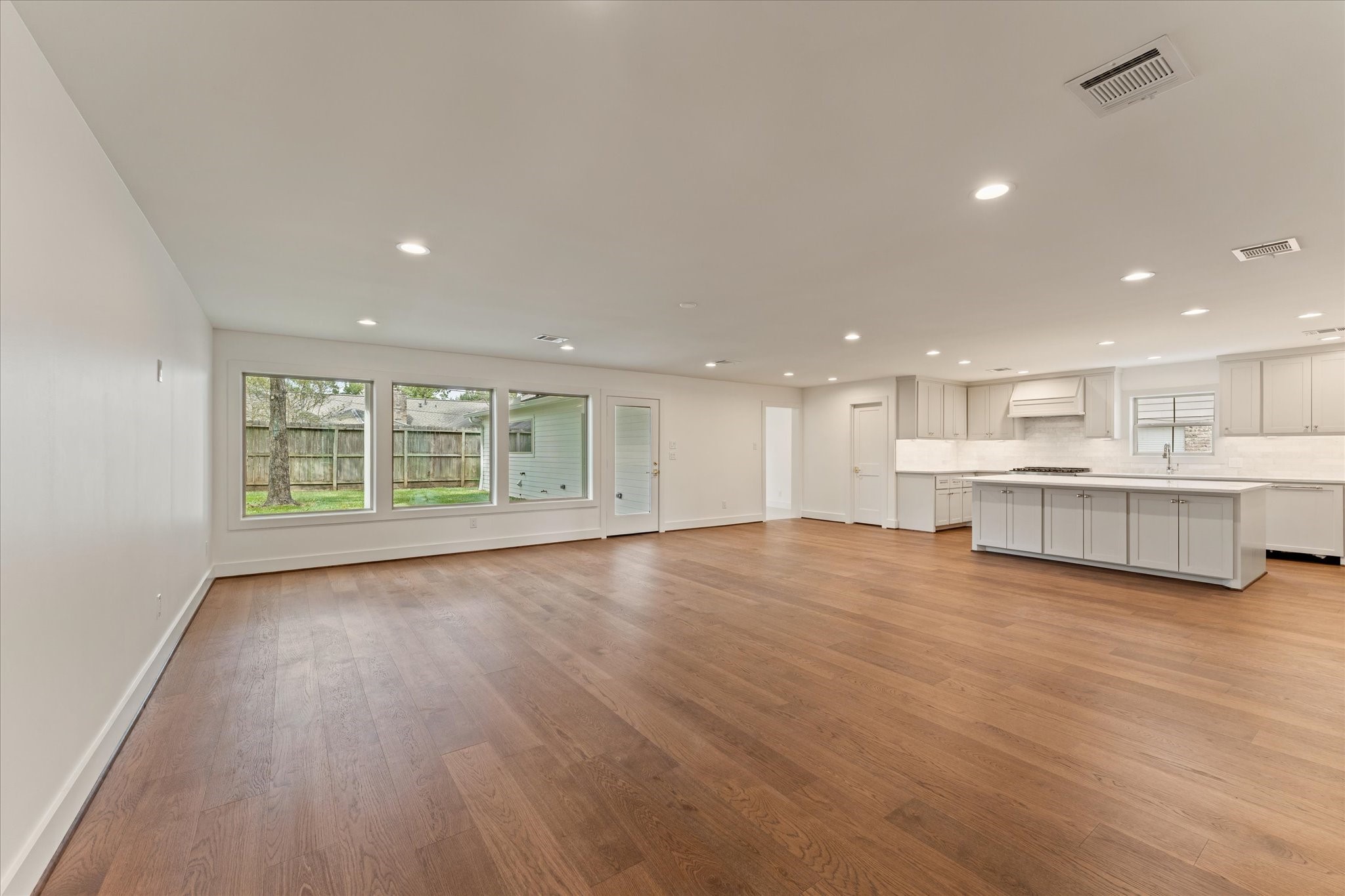 Open and spacious living space into the kitchen with custom cabinetry Open and spacious living space into the kitchen with custom cabinetry