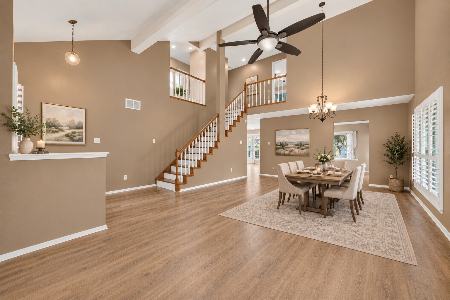 Spacious and grand, this dining area features open views offering plenty of room for a full-sized table to gather everyone together. (virtual staged)