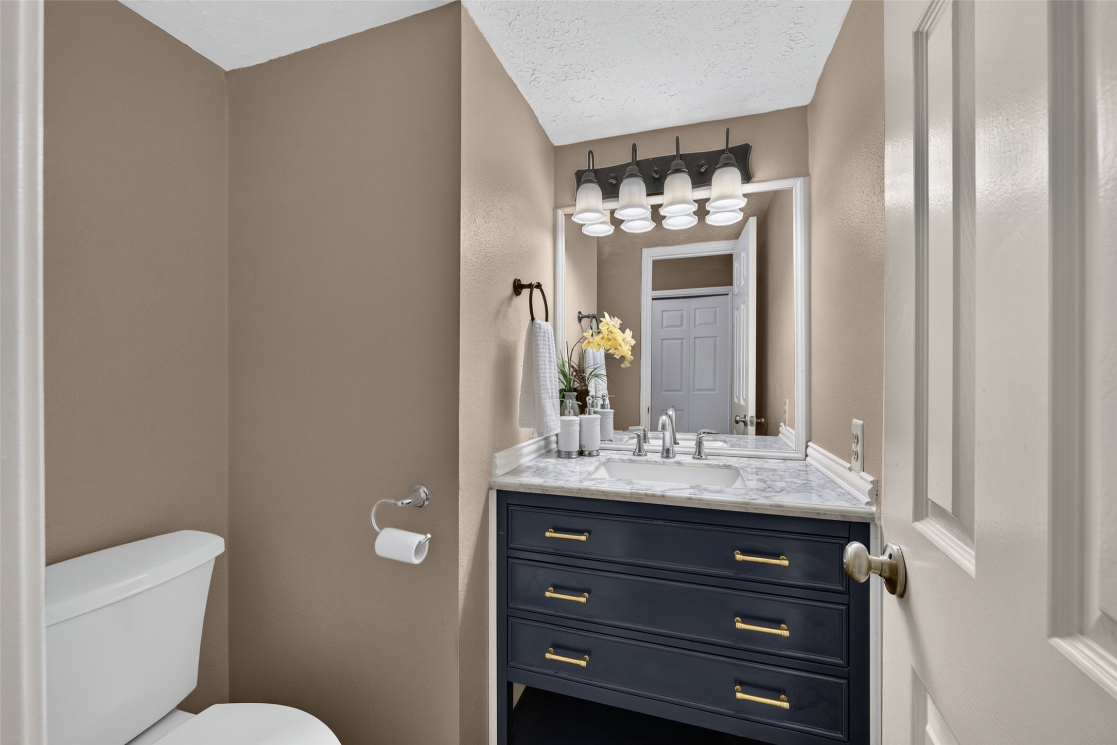 A stylish half bath conveniently located on the main floor, complete with clean finishes and updated, high-end fixtures that give your guests a pristine and charming impression.