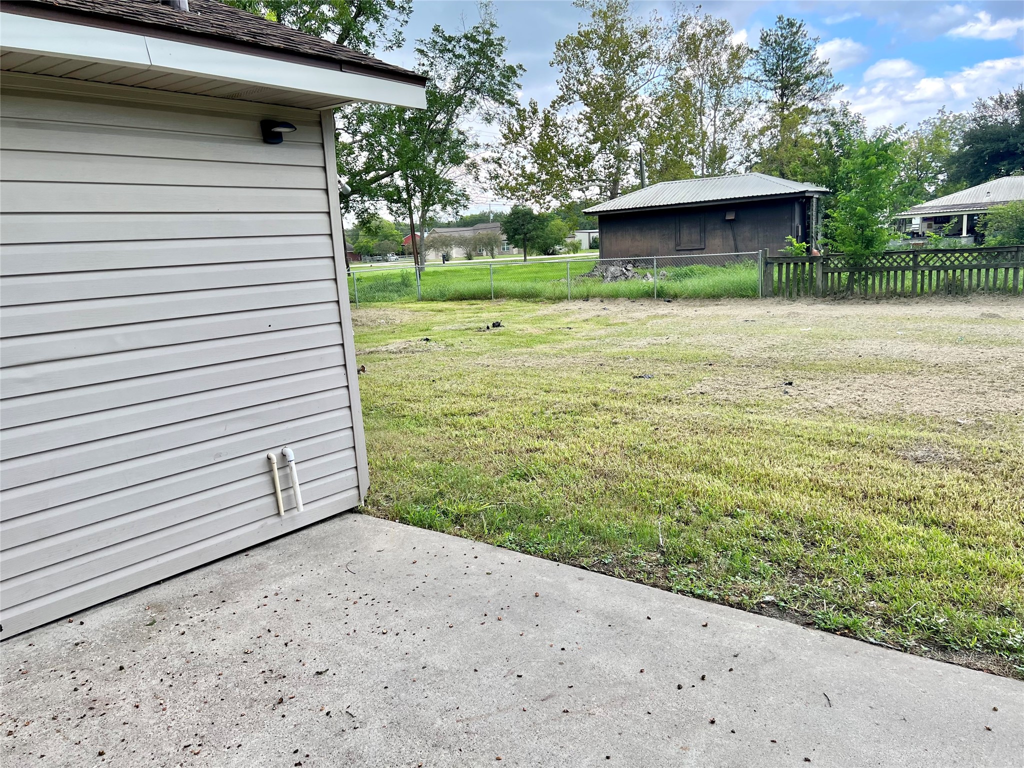 Great back patio area for BBQ and another separated fenced area in the back of the home.