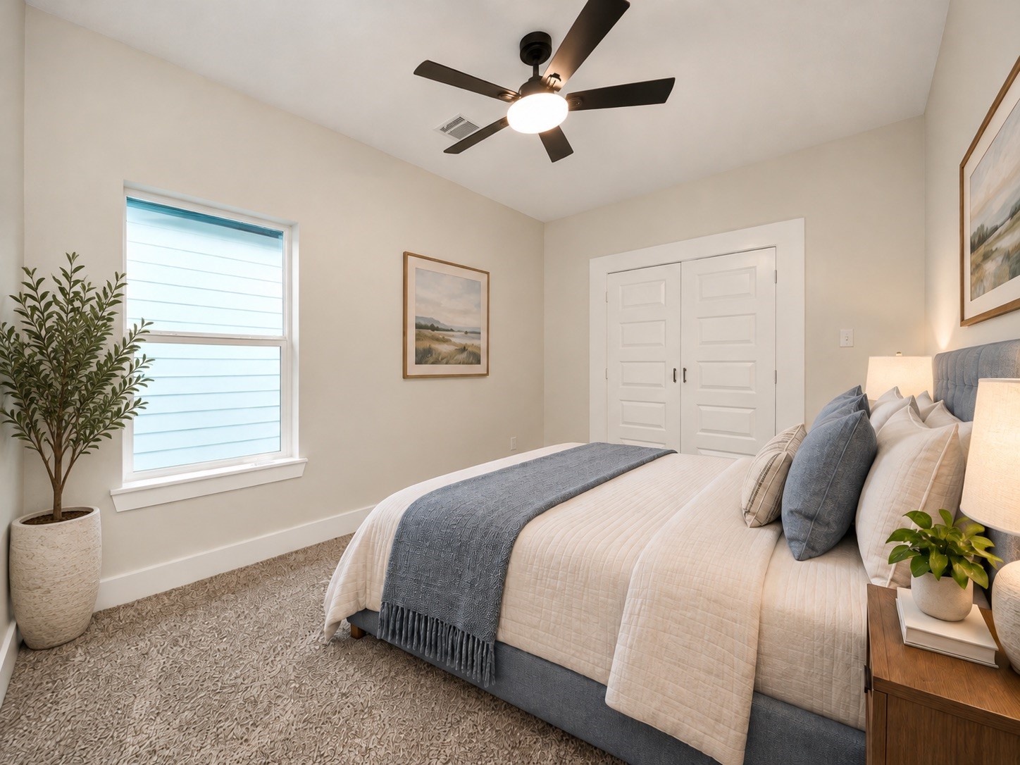 This second-floor secondary bedroom measures approximately 14 x 10 feet and features a ceiling fan, natural light, and a neutral color palette. The room is conveniently located near the shared bathroom. | Virtually Staged