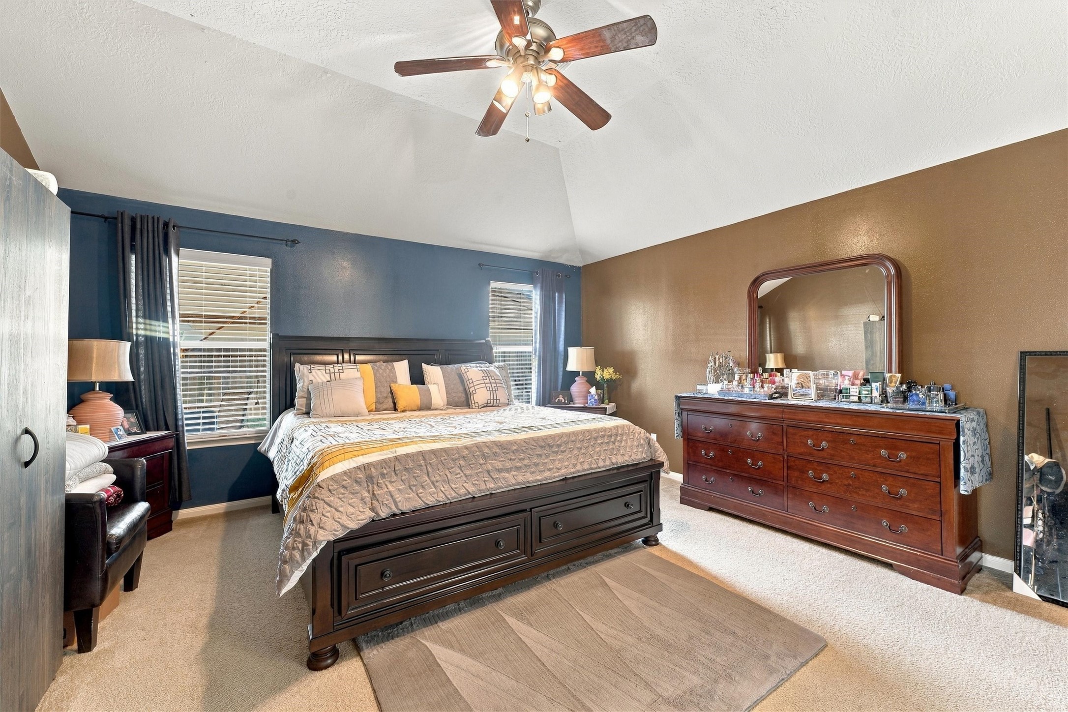 Spacious bedroom with a vaulted ceiling.