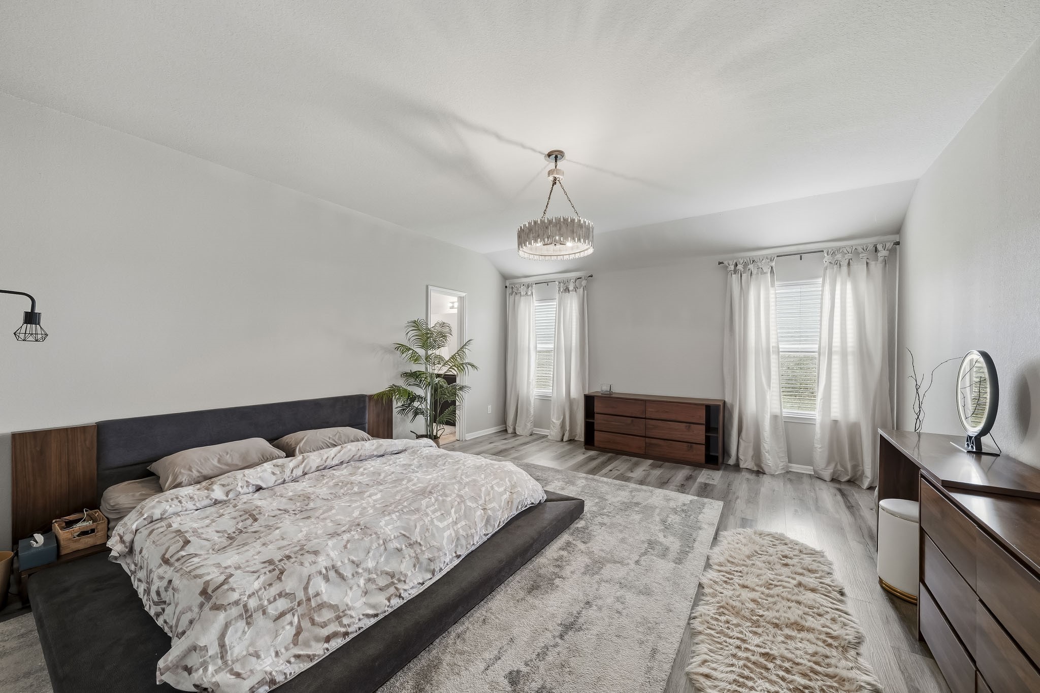 Retreat to the generously sized primary suite, complete with comfortable furnishings, beautiful natural light, and ample room to relax and unwind.