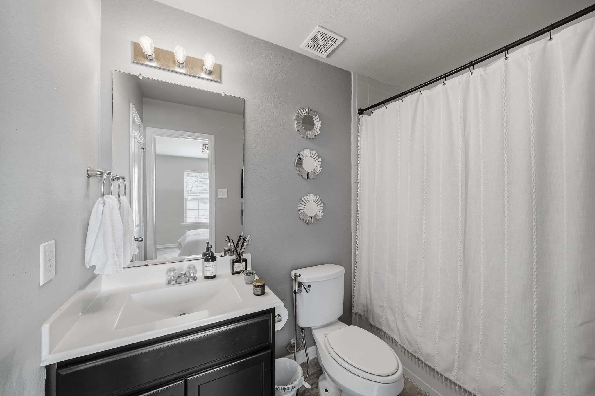 A clean, well-appointed bathroom features a spacious vanity, contemporary finishes, and a shower and tub combination for everyday convenience. A clean, well-appointed bathroom features a spacious vanity, contemporary finishes, and a shower and tub combination for everyday convenience.