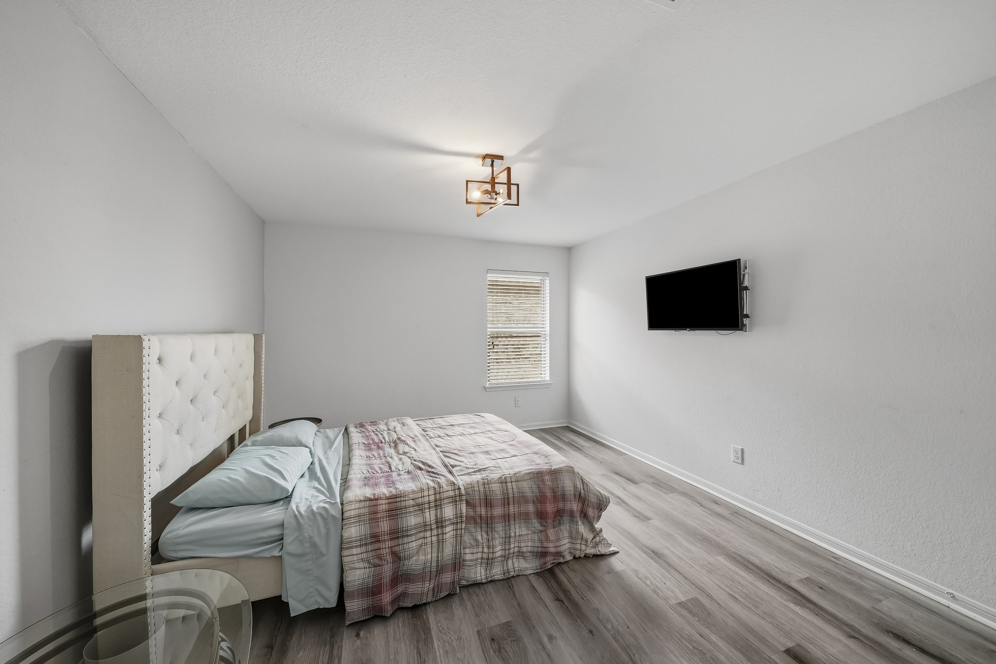 Another generously sized bedroom provides flexibility and comfort, with natural light, contemporary flooring, and a welcoming atmosphere.