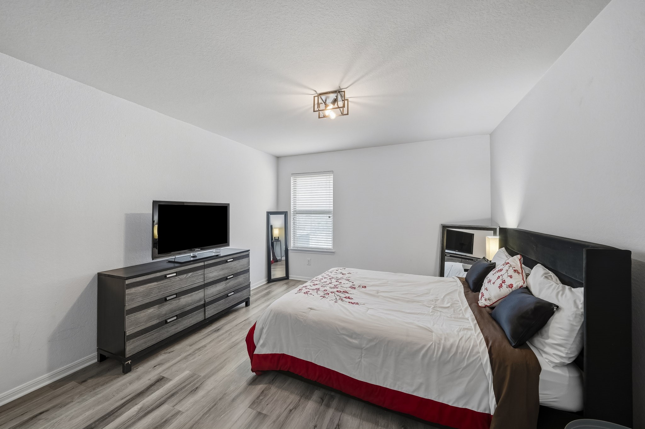 A spacious bedroom offers comfortable furnishings, attractive flooring, and a relaxed setting designed for restful evenings. A spacious bedroom offers comfortable furnishings, attractive flooring, and a relaxed setting designed for restful evenings.