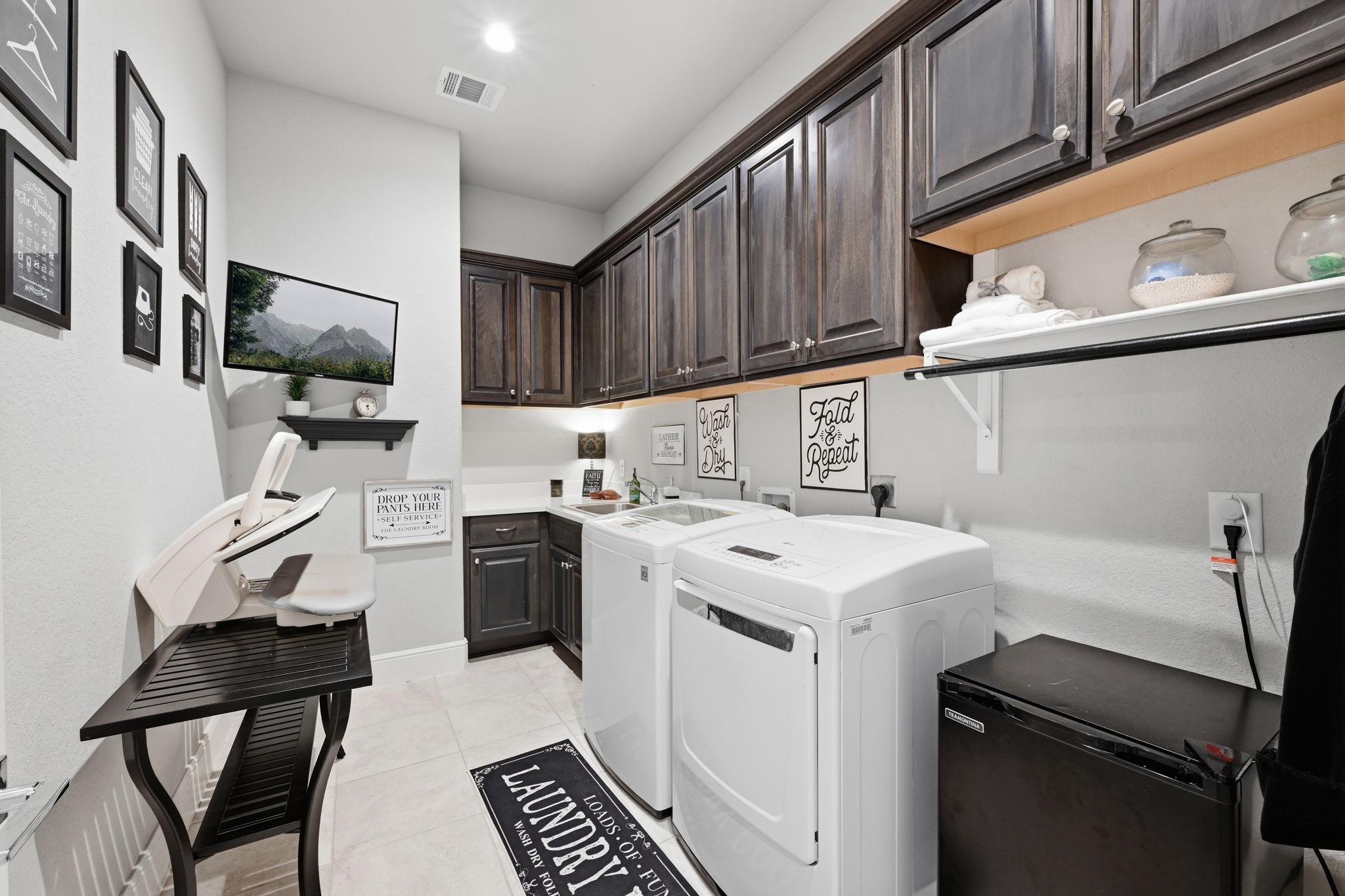 Laundry room with ample cabinetry.