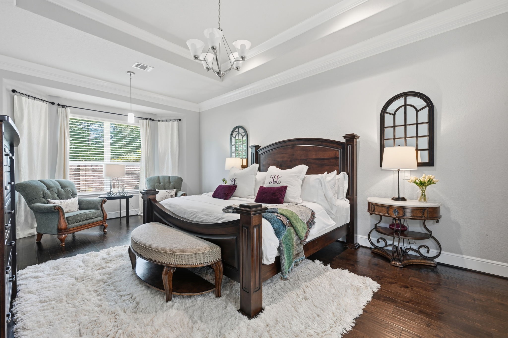 Primary bedroom features a trey ceiling and sitting area.