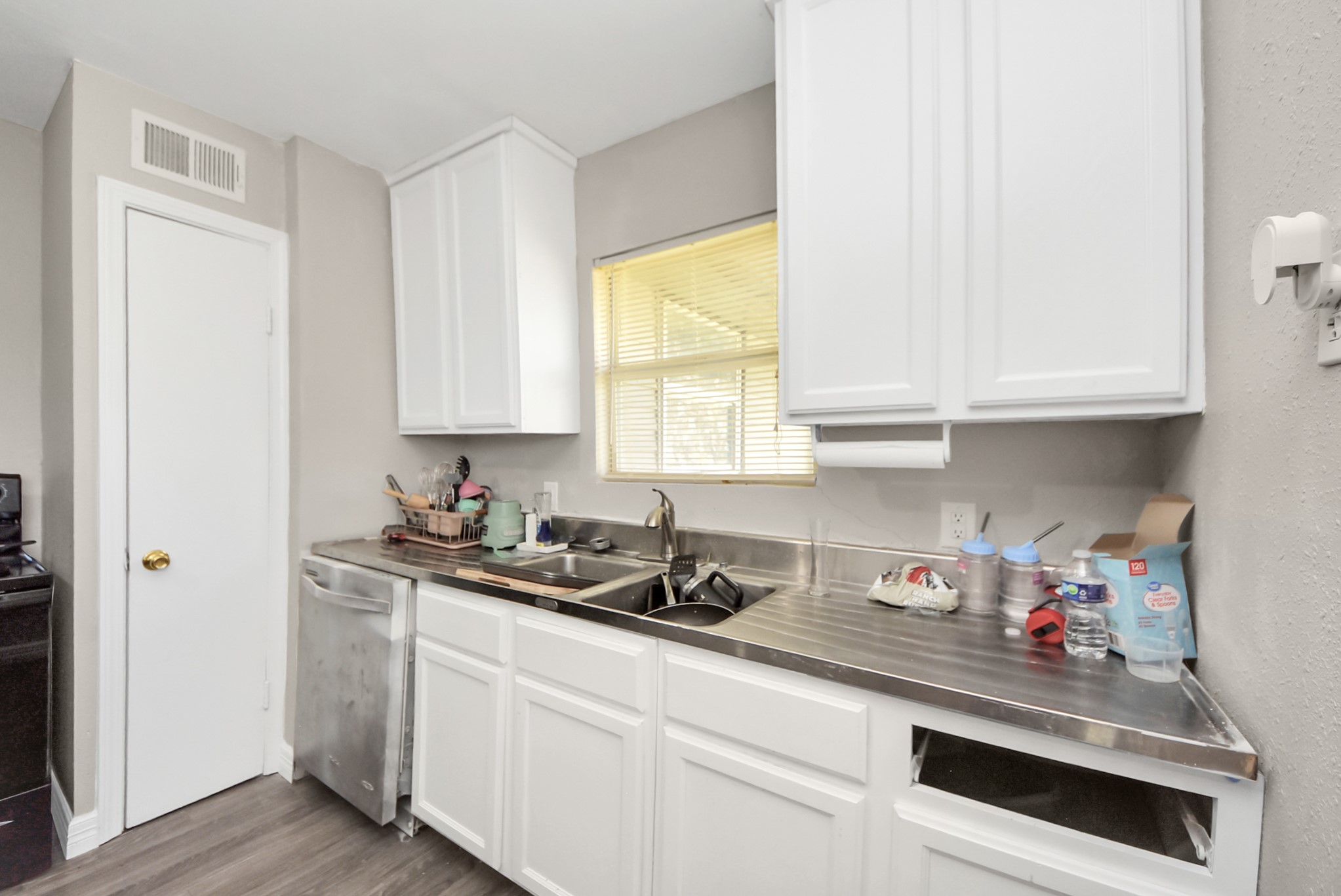 unit 1 kitchen sink area and pantry door